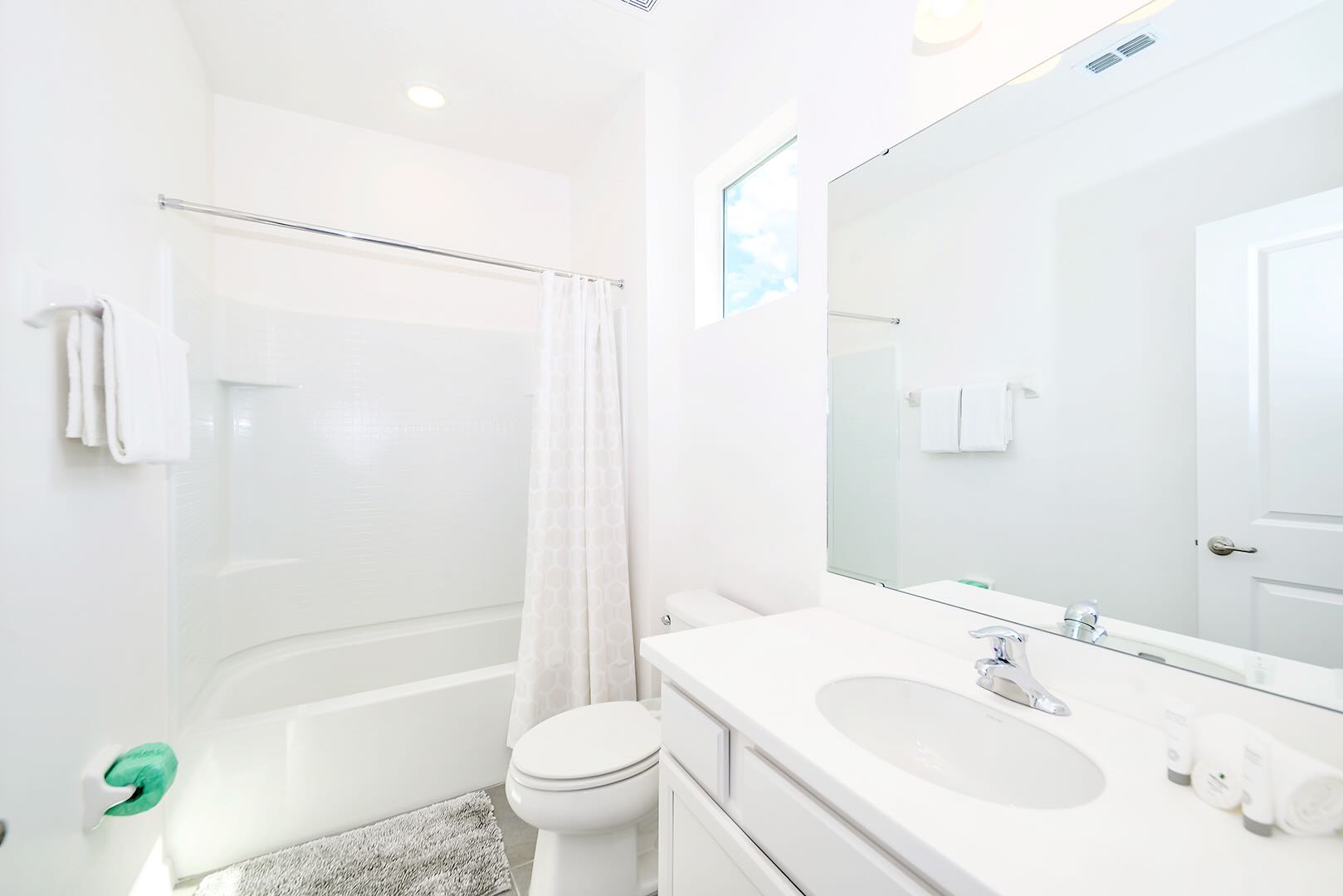 Bright Bathroom Featuring Ample Counter Space And Elegant Fixtures