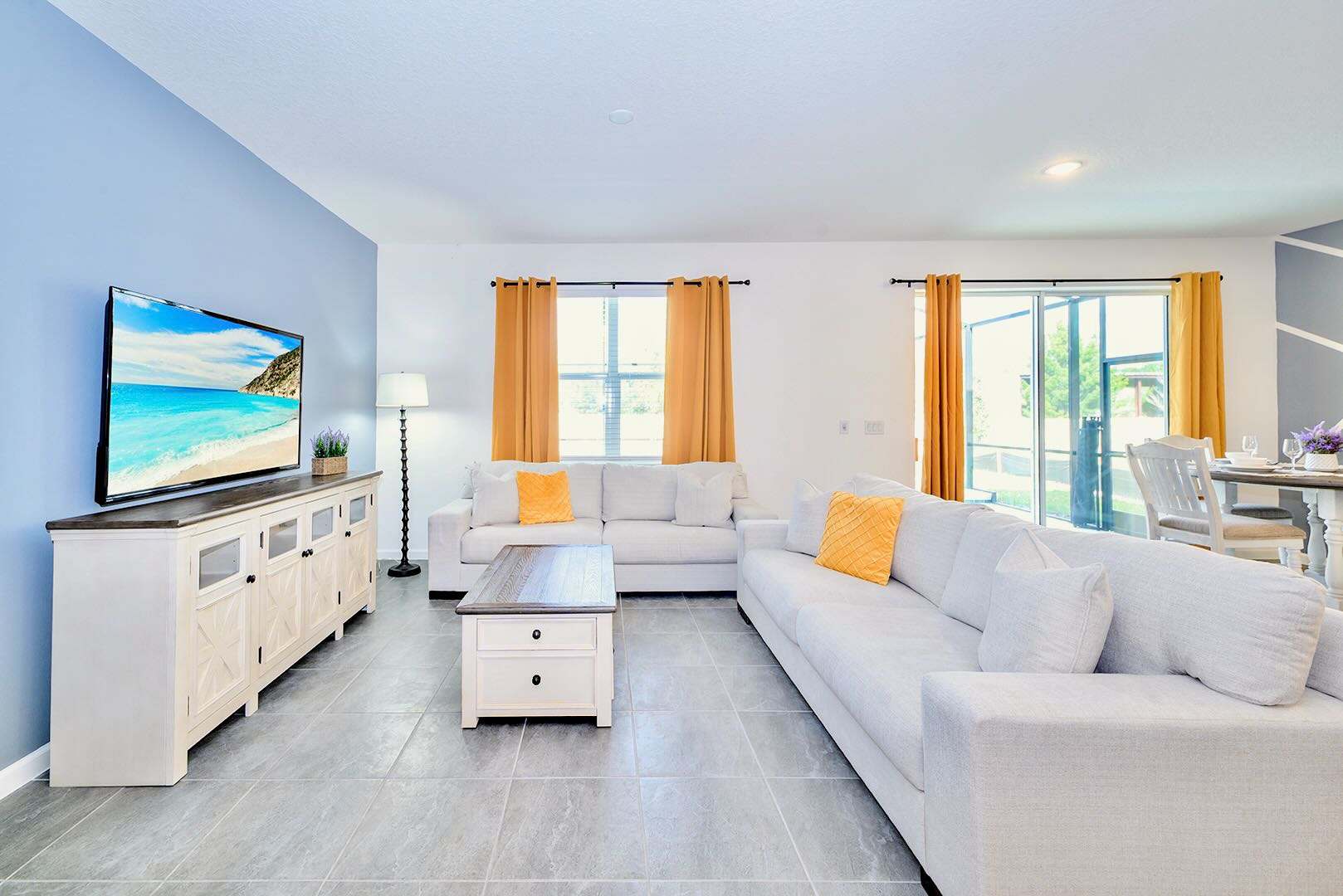 Bright And Spacious Living Room With A Mounted Smart TV