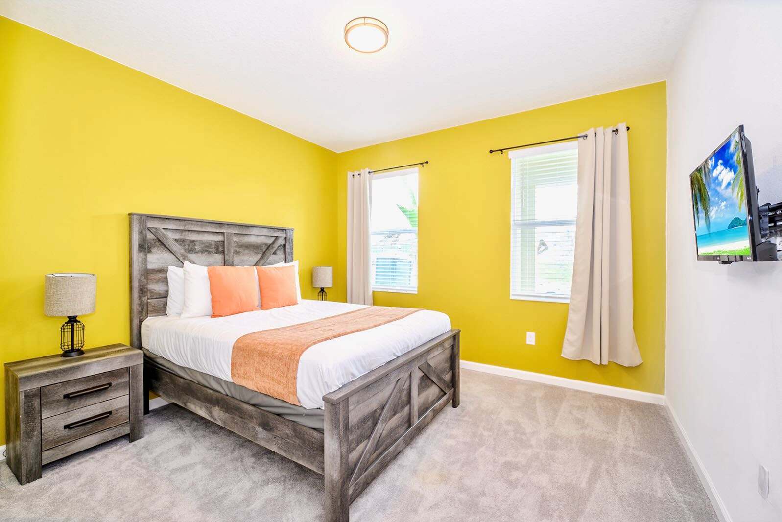 Vibrant Bedroom With Bold Yellow Accent Wall And Queen Bed