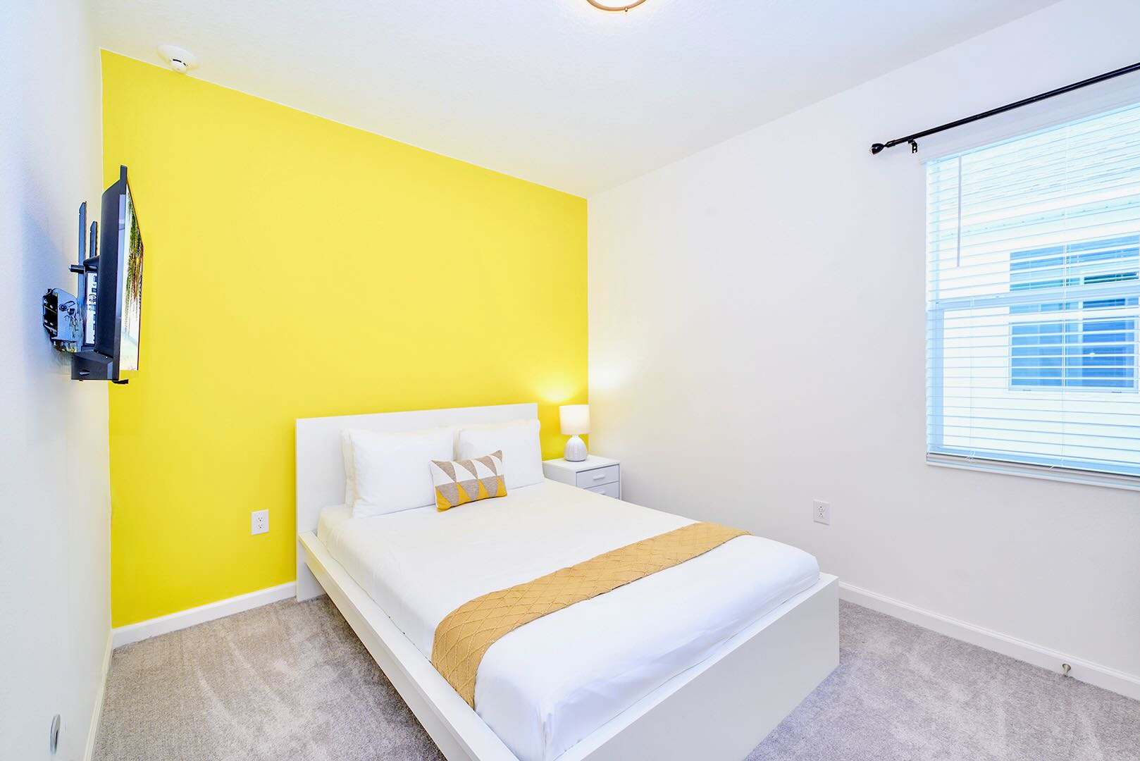 Bright Room With Bold Yellow Wall And Smart TV For Entertainment