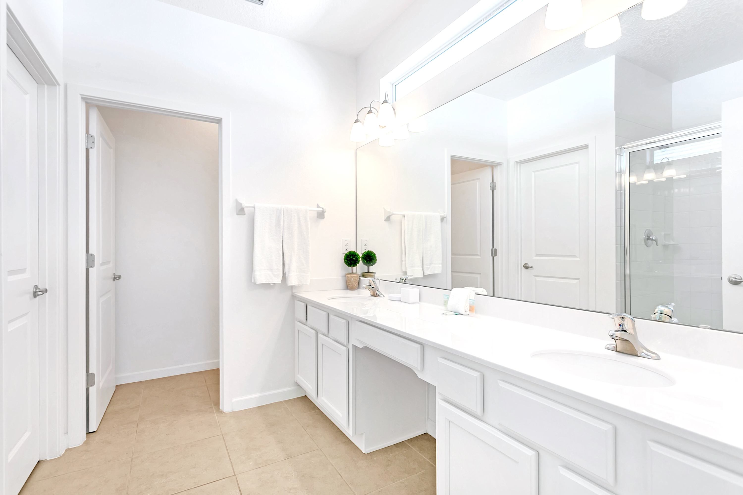 Bright Bathroom With Spacious Countertops And Shower Tub Combo