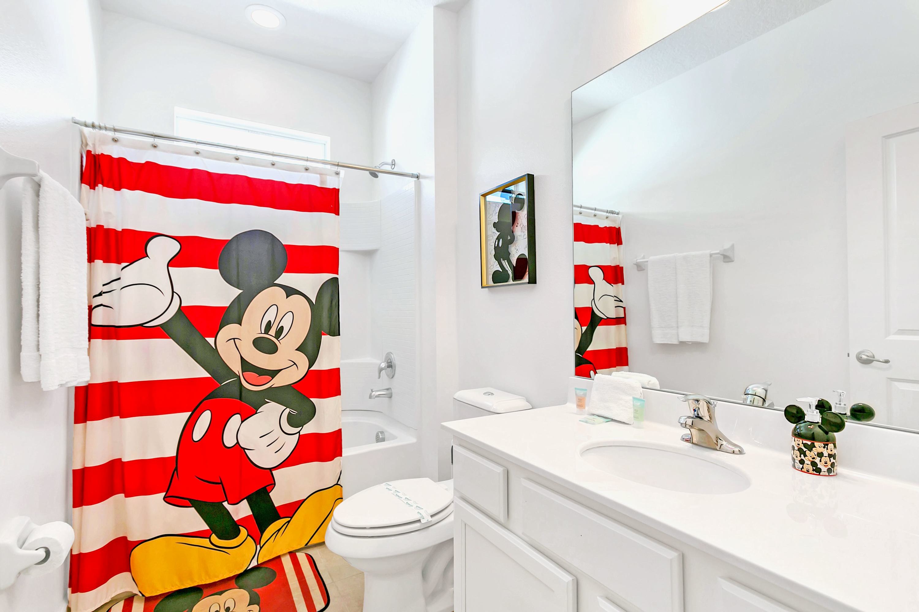 Bright Bathroom Featuring A Mickey Mouse Themed Shower Curtain