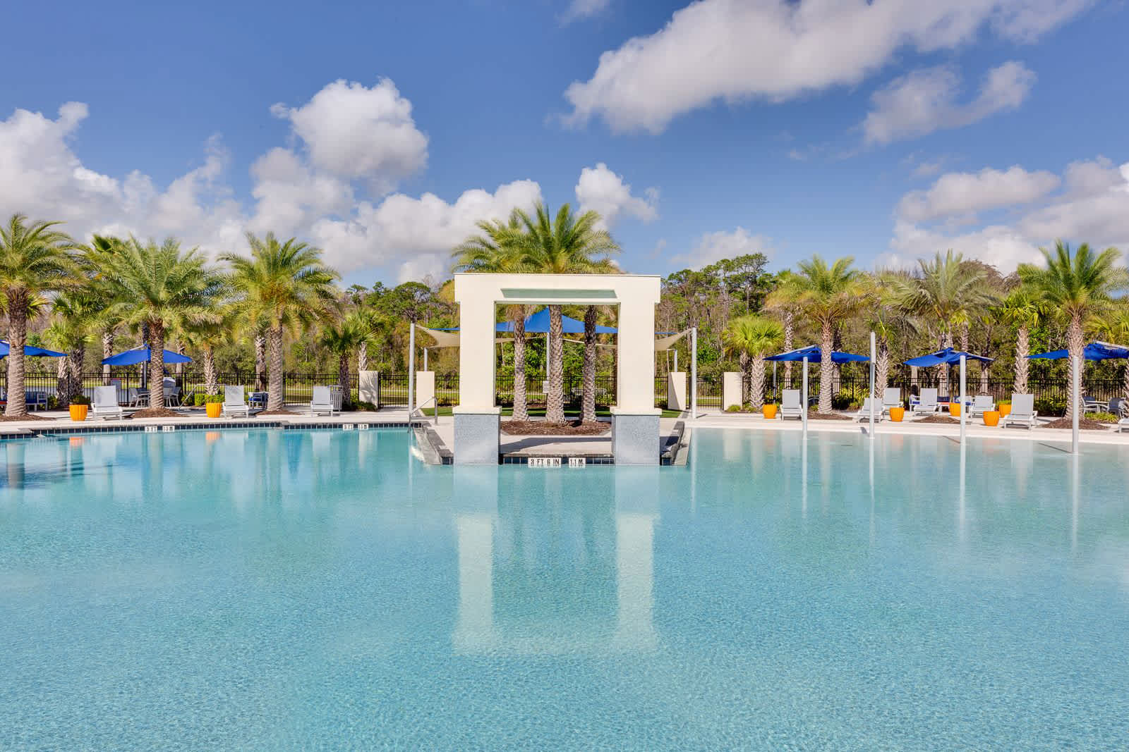 Expansive Resort Pool With Sparkling Water And Poolside Loungers
