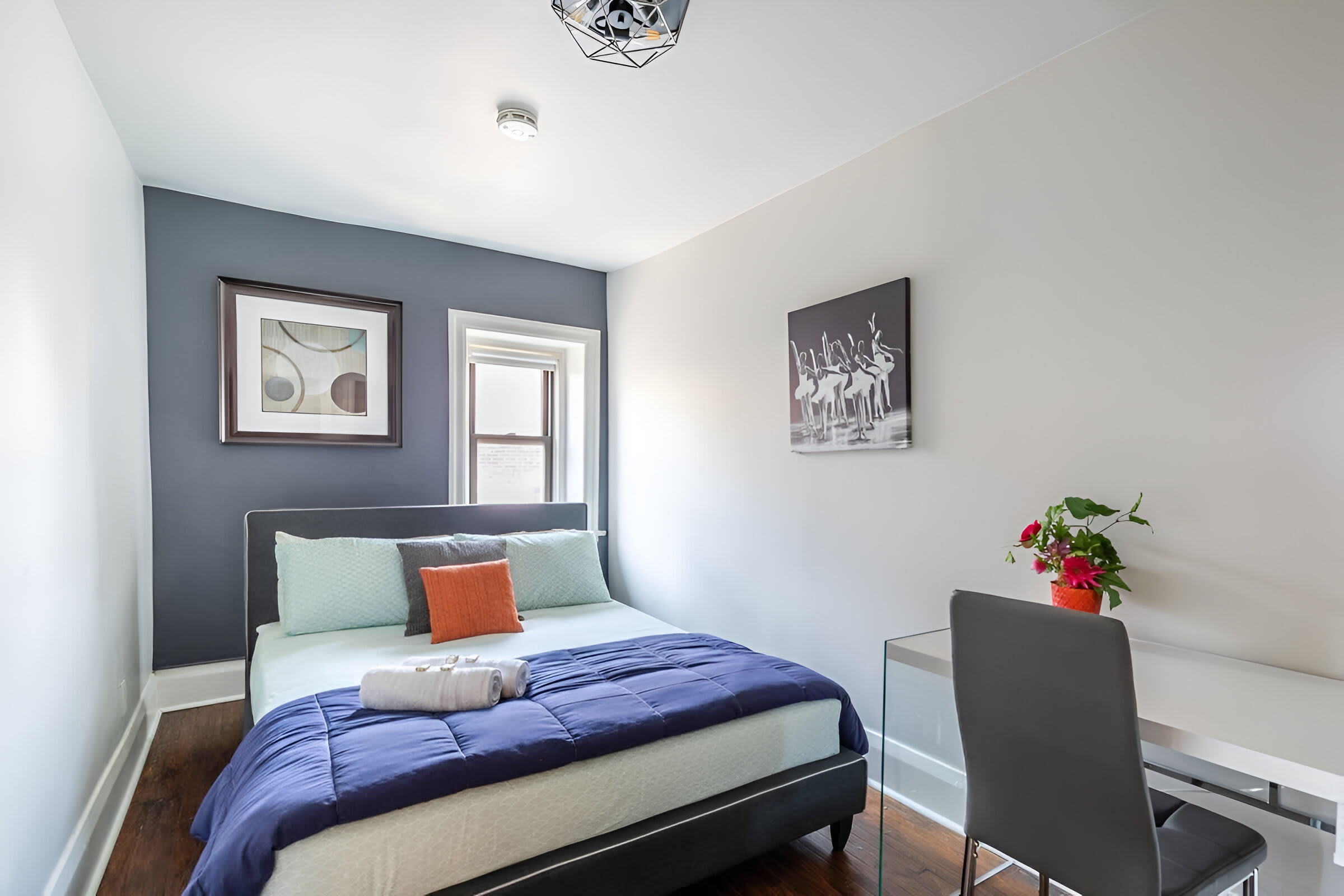 Bright Bedroom With Queen Bed And Artistic Wall Decor