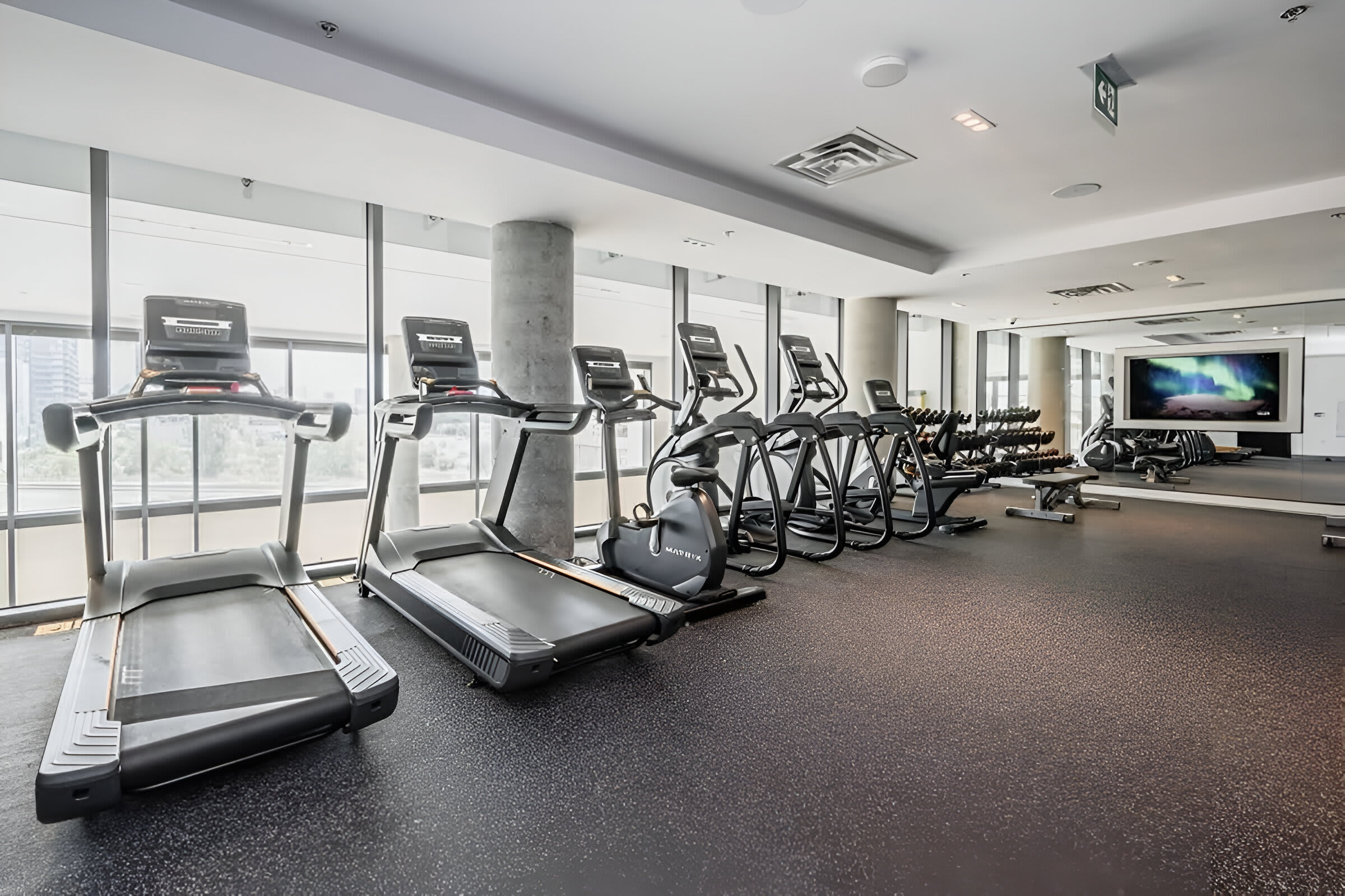 Fully Equipped Fitness Center With Treadmills And Strength-Training Machines