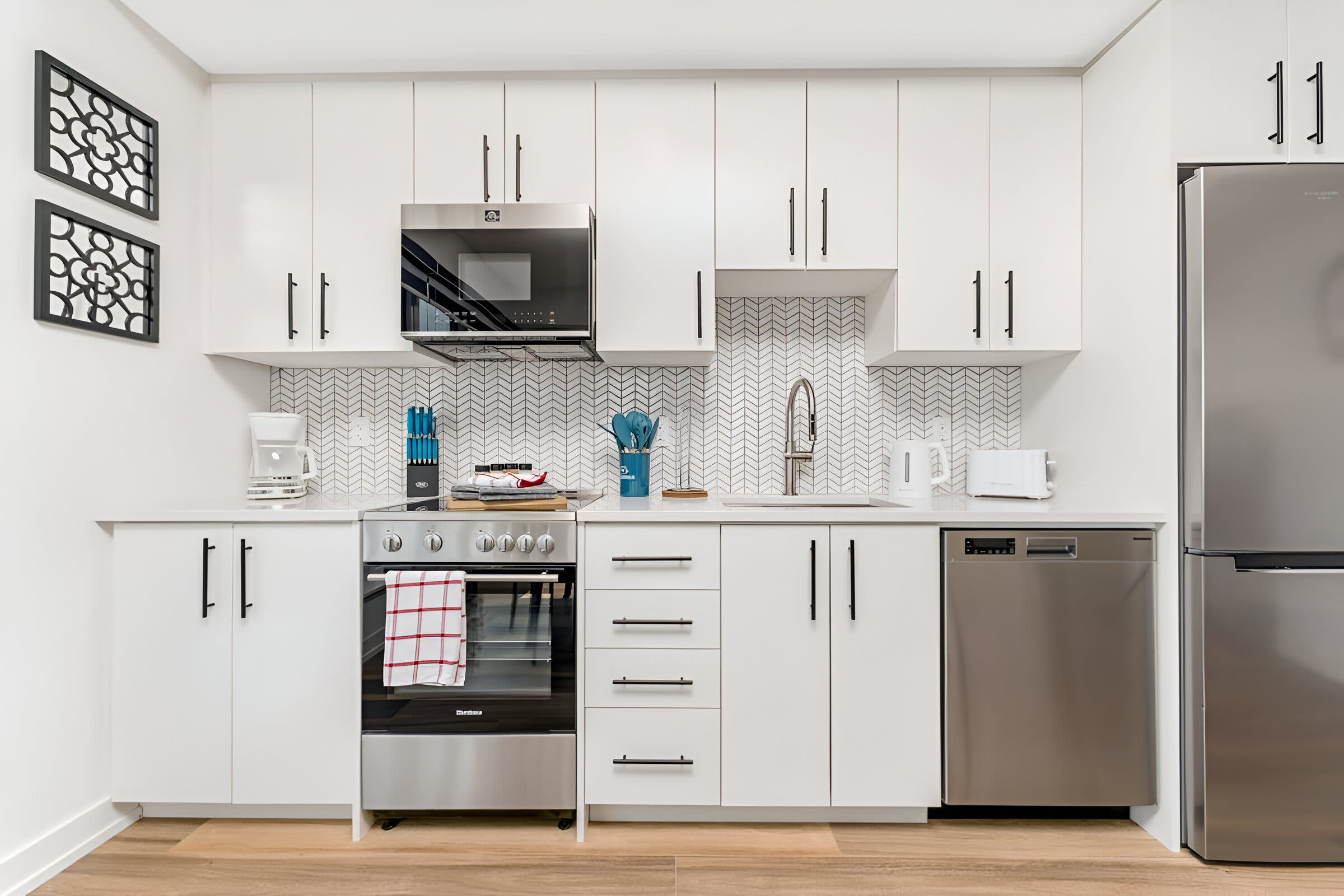 Fully Equipped Kitchen With Stainless Steel Appliances And Quartz Countertops