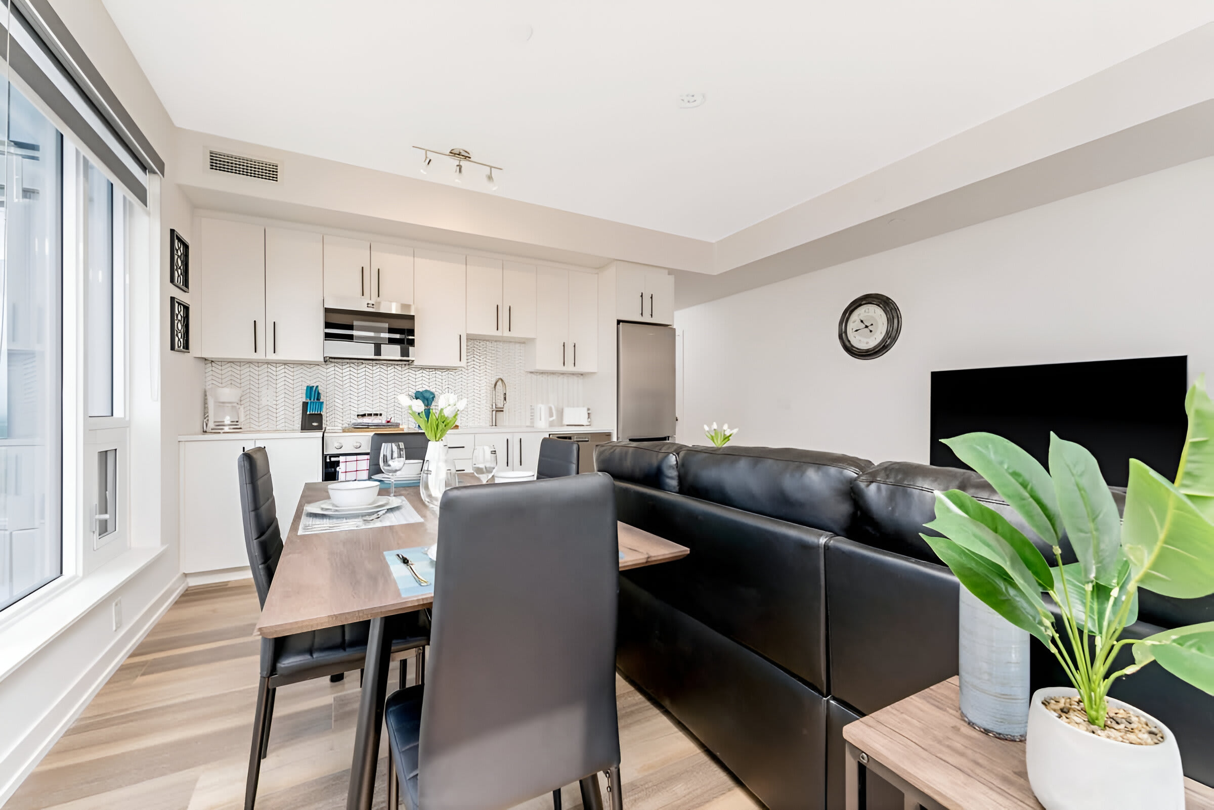 Open-Concept Living And Dining Area With Modern Furniture And Bright Natural Light