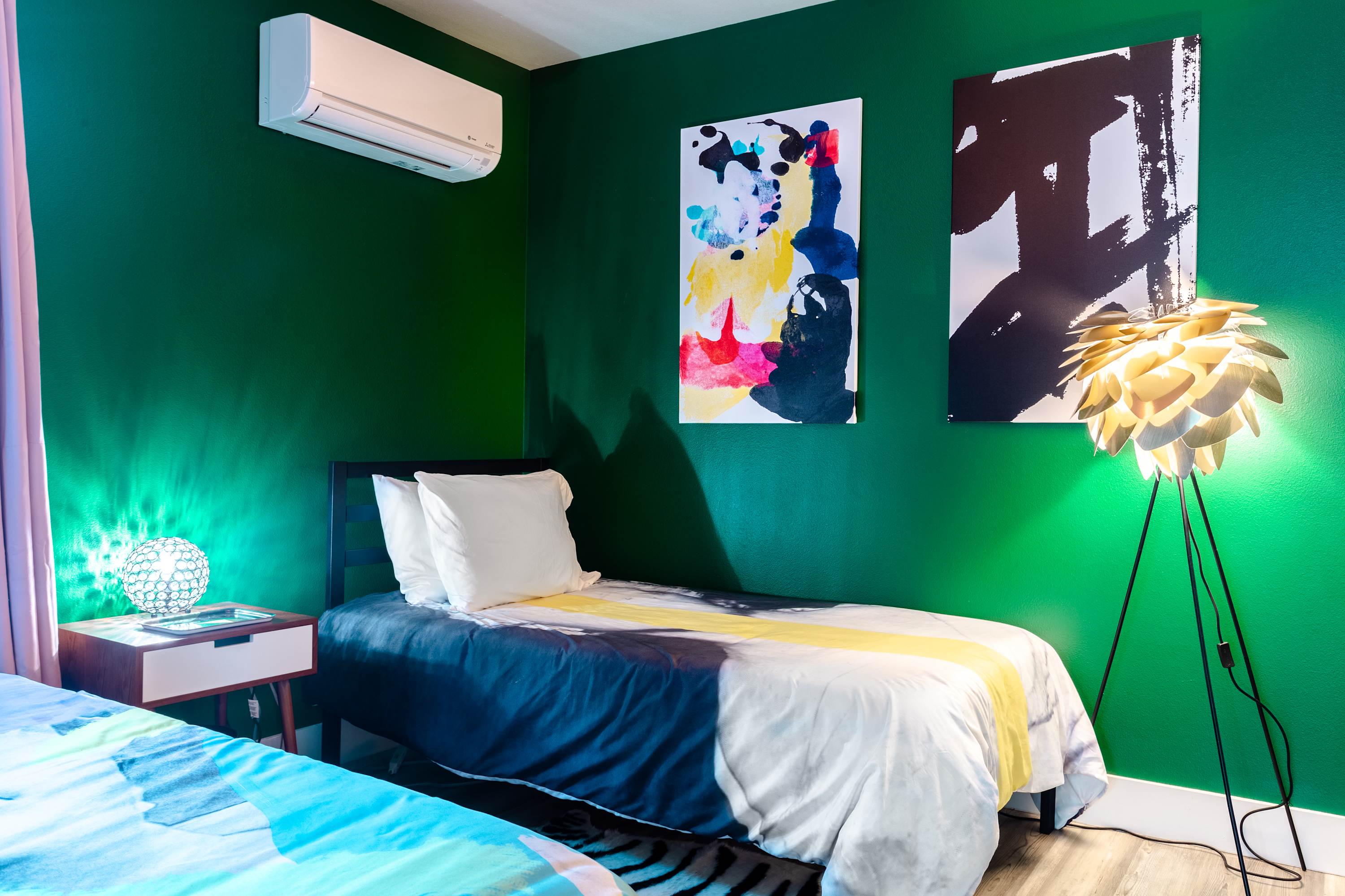 Cozy Bedroom With Twin Bed, Modern Art, And Vibrant Green Walls