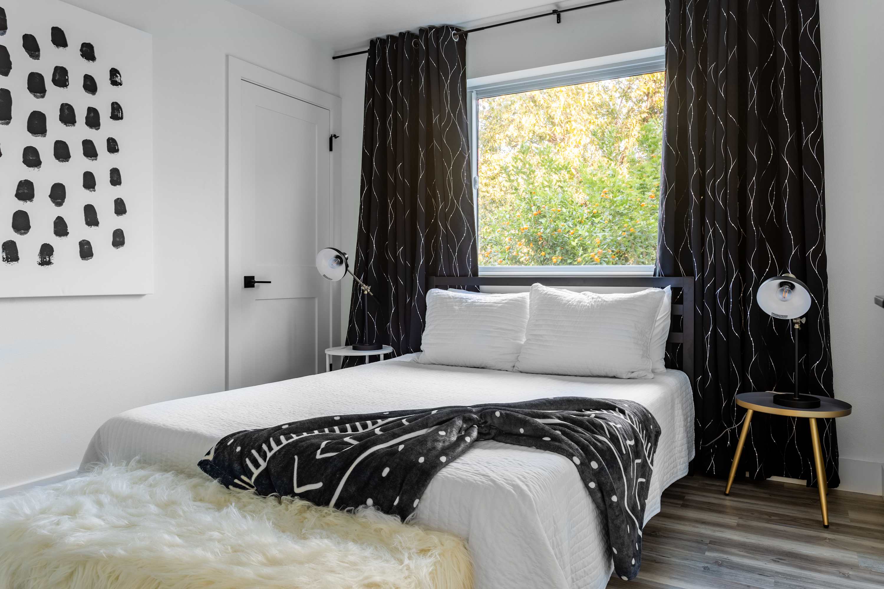 Queen Bed With Minimalist Black-And-White Decor And Natural Light