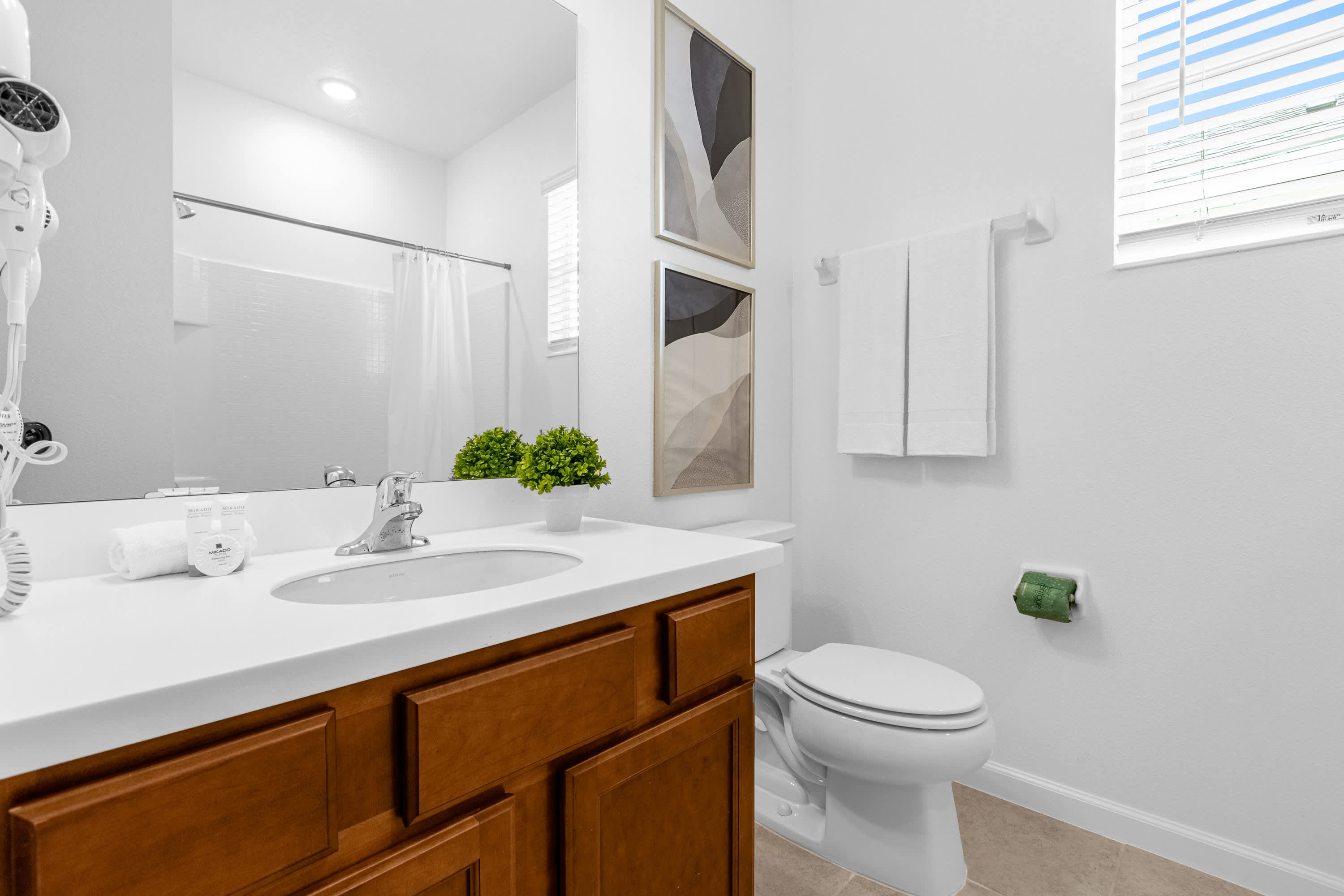 Elegant Bathroom Featuring Dual Sinks And Modern Lighting