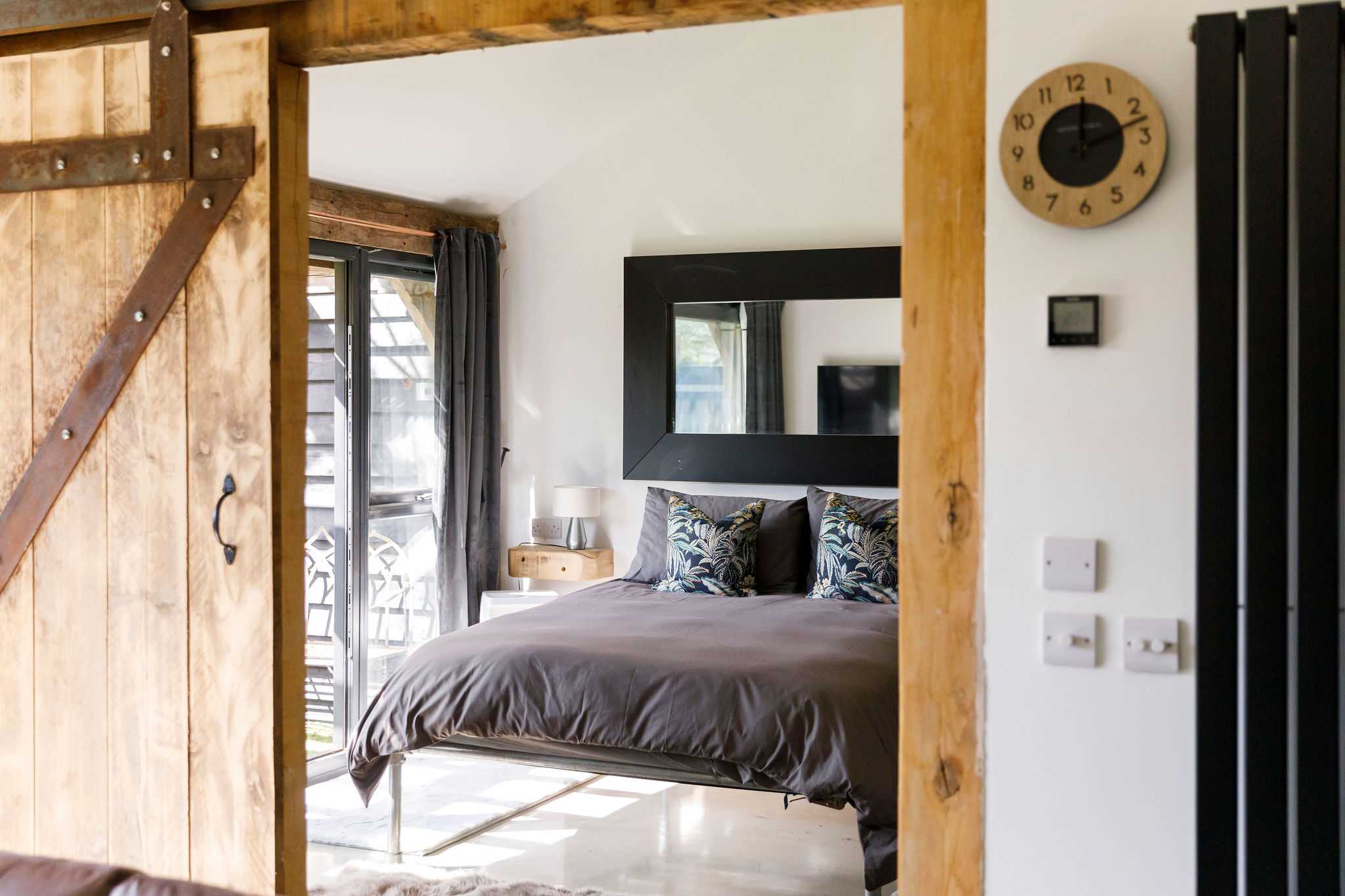 Open up the pocket door into the contemporary master bedroom.