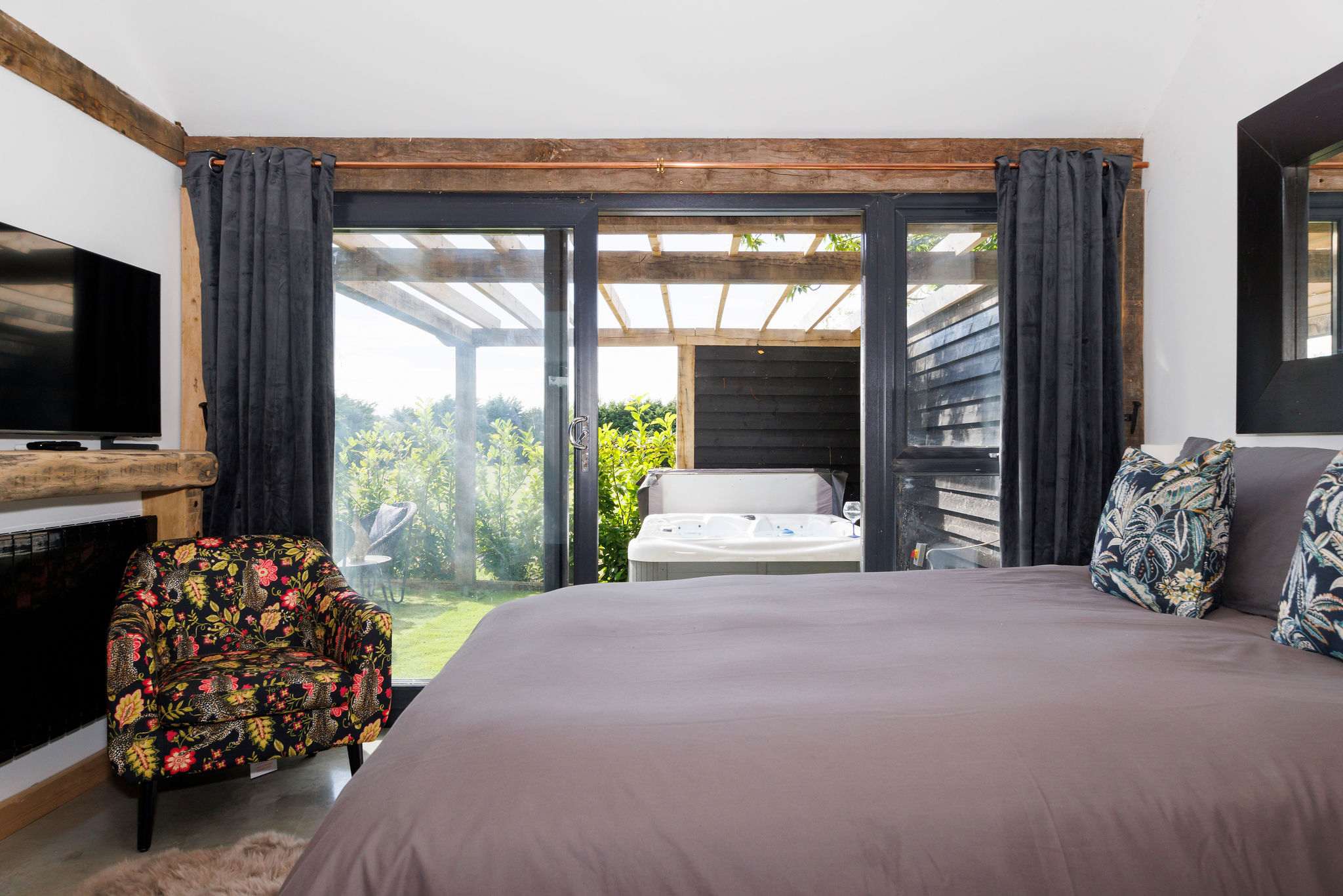 Relax in bed with views out to the courtyard and fields beyond.