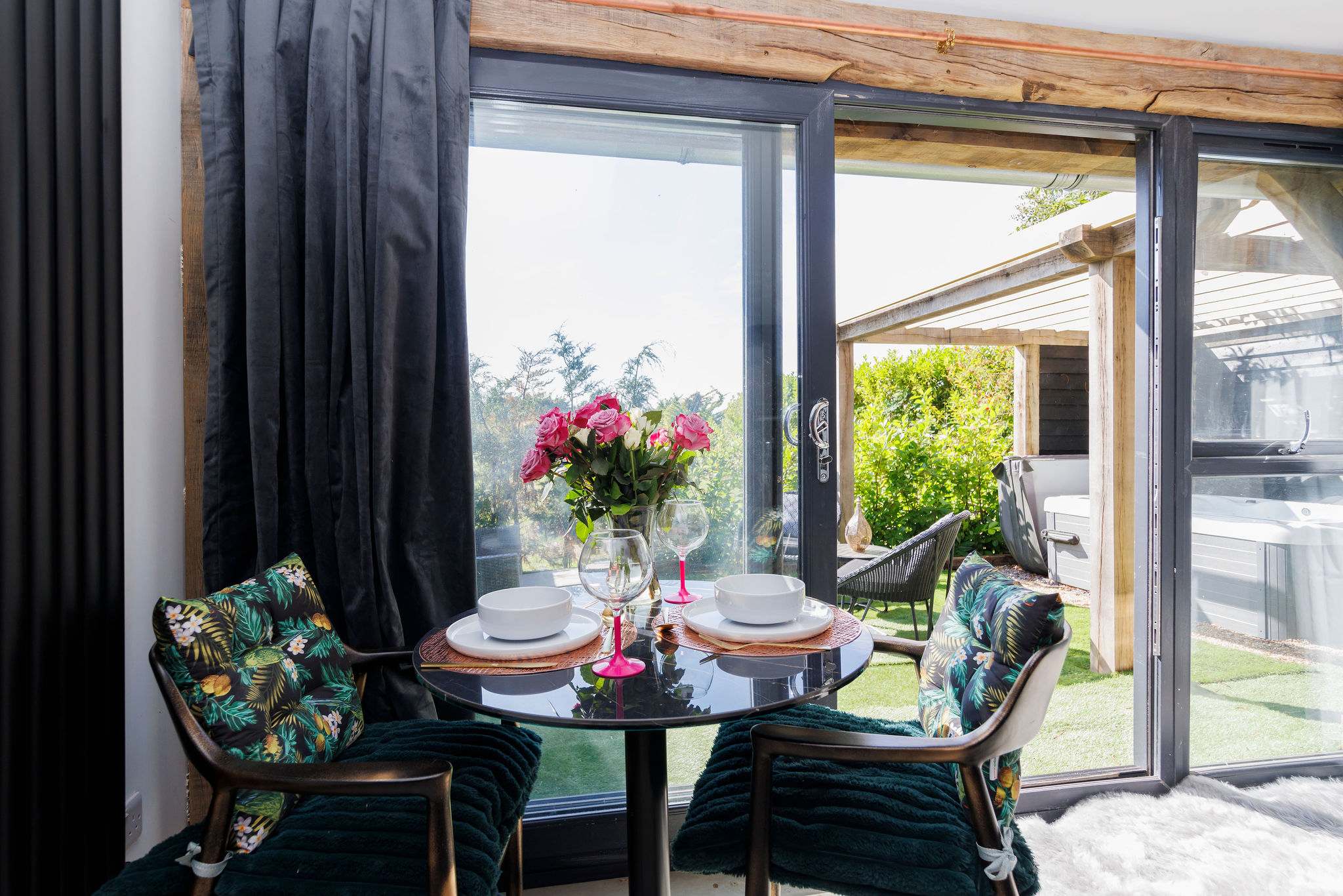 Dining at a table for two while enjoying the view of the greenery, creates a romantic and relaxing atmosphere.