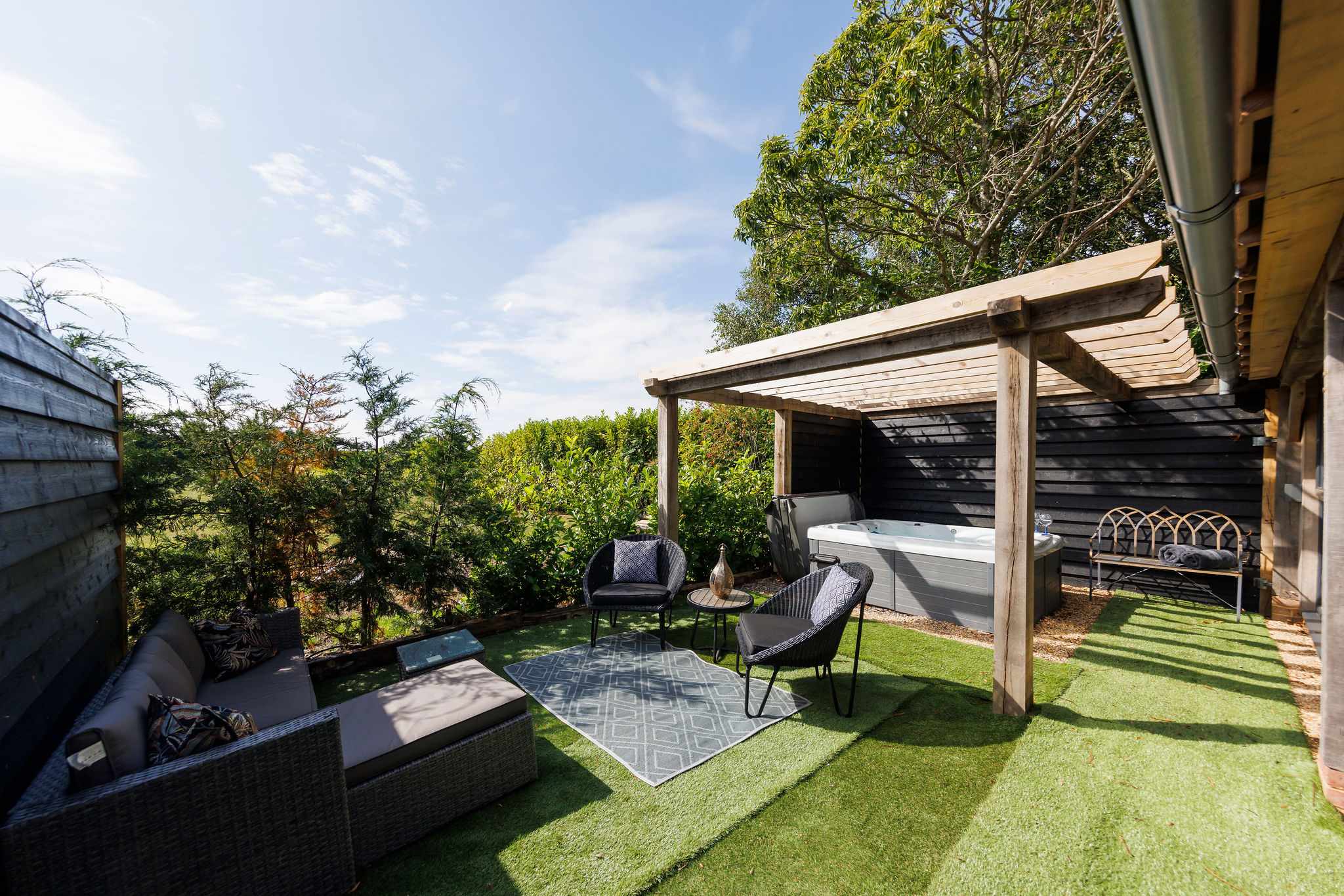 The superb outdoor space has plenty of places to sit. Not to mention the hot tub!