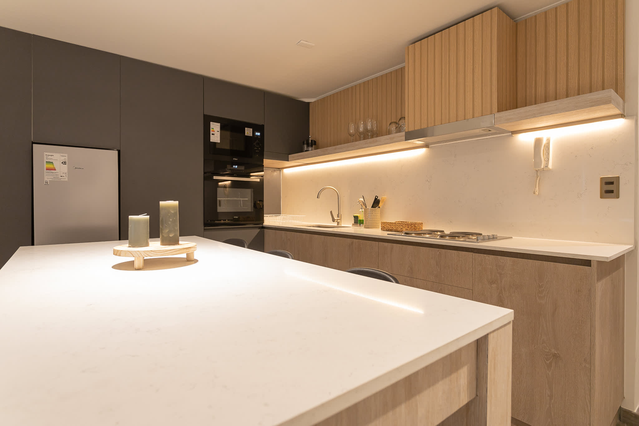 Sleek and modern kitchen with spacious counters and stylish lighting, ideal for culinary creativity.