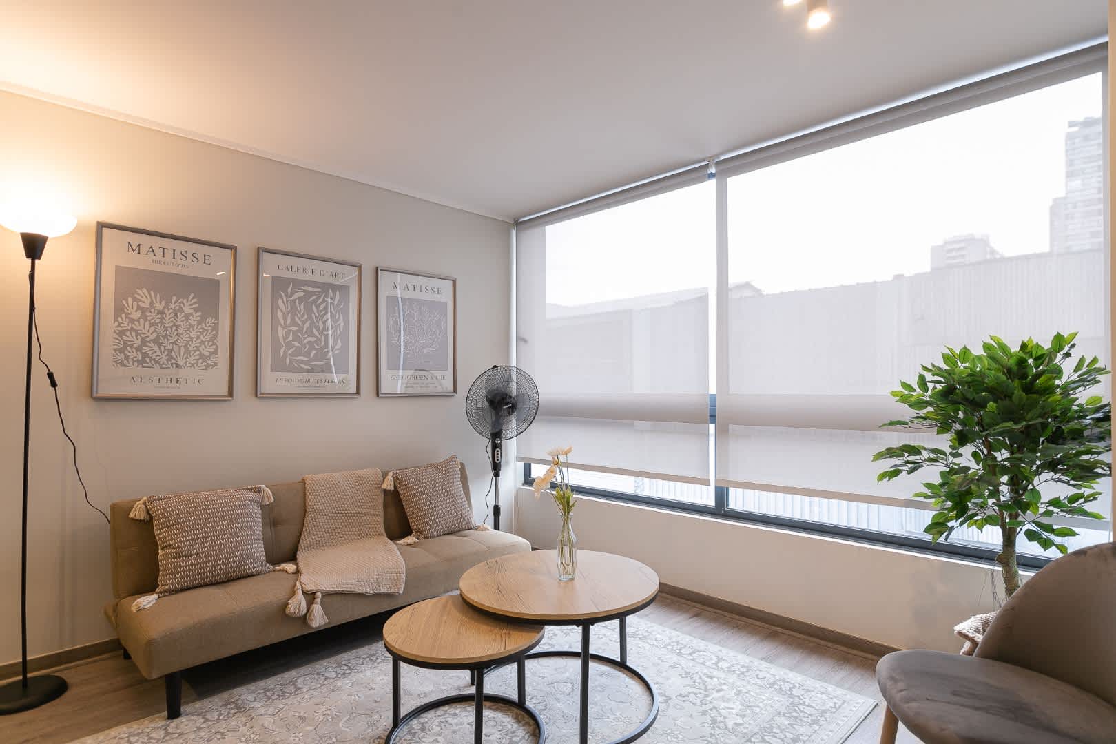 Relax in this stylish and cozy living area with modern decor and ample natural light, perfect for unwinding after a day in the city.