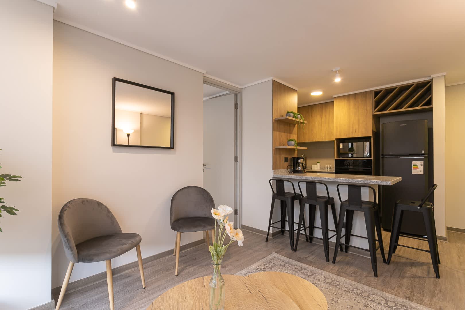 Cozy and modern studio with a stylish kitchen bar, perfect for relaxing or enjoying a meal.