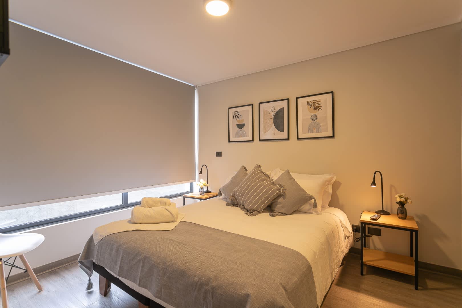 Relax in this stylish and cozy bedroom, complete with modern decor and soft lighting for a restful stay.
