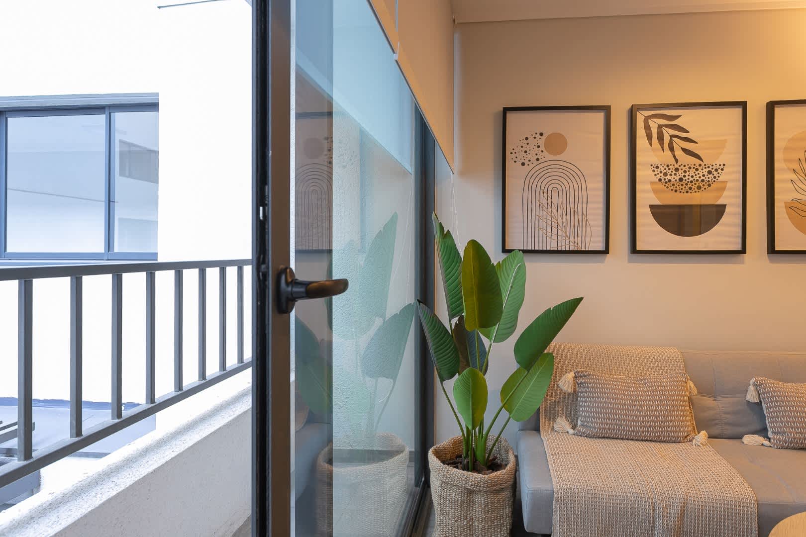 Relax in this cozy living space with stylish decor and a touch of greenery, perfect for unwinding after exploring the city.