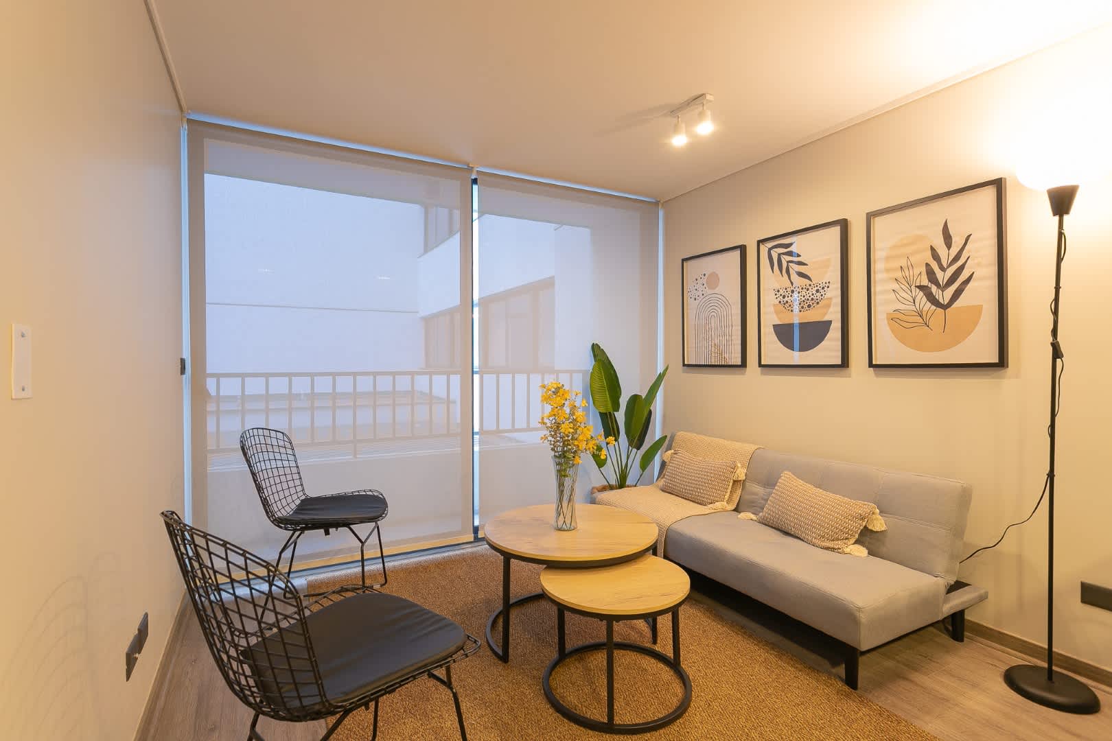Cozy and stylish living space with modern decor and natural light, perfect for relaxing after exploring the city.