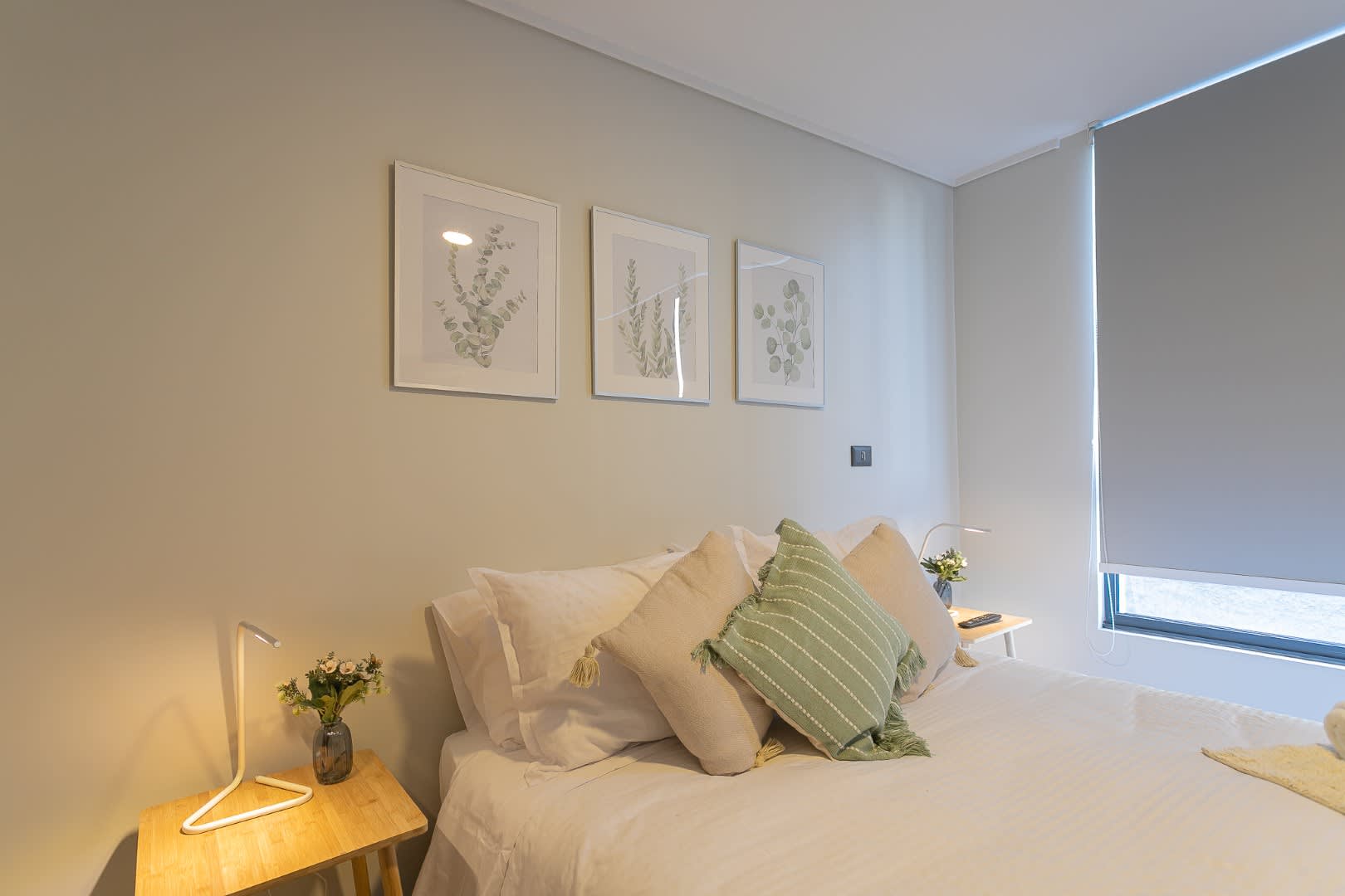 Relax in this serene bedroom with cozy decor and soft lighting, perfect for unwinding after a day exploring the city.