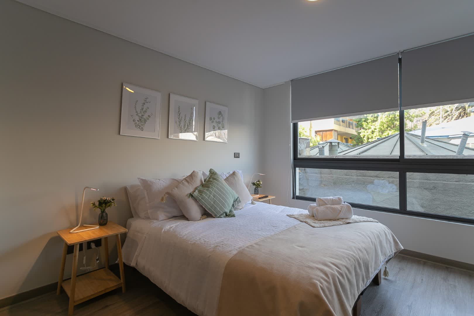 Relax in this cozy bedroom with a serene view and modern decor, perfect for a peaceful getaway.