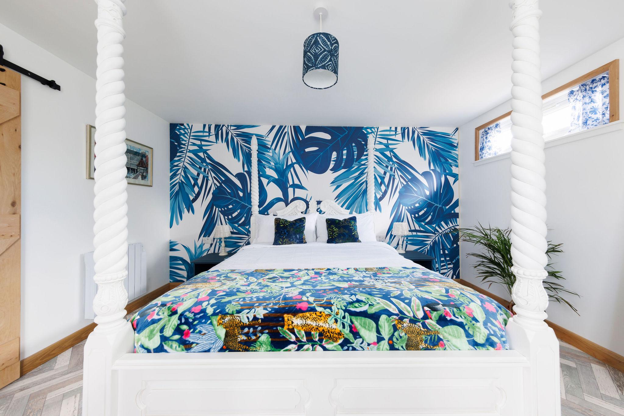 The feature wall really adds character creating a warm and inviting atmosphere, especially when paired with a comfy king bed.