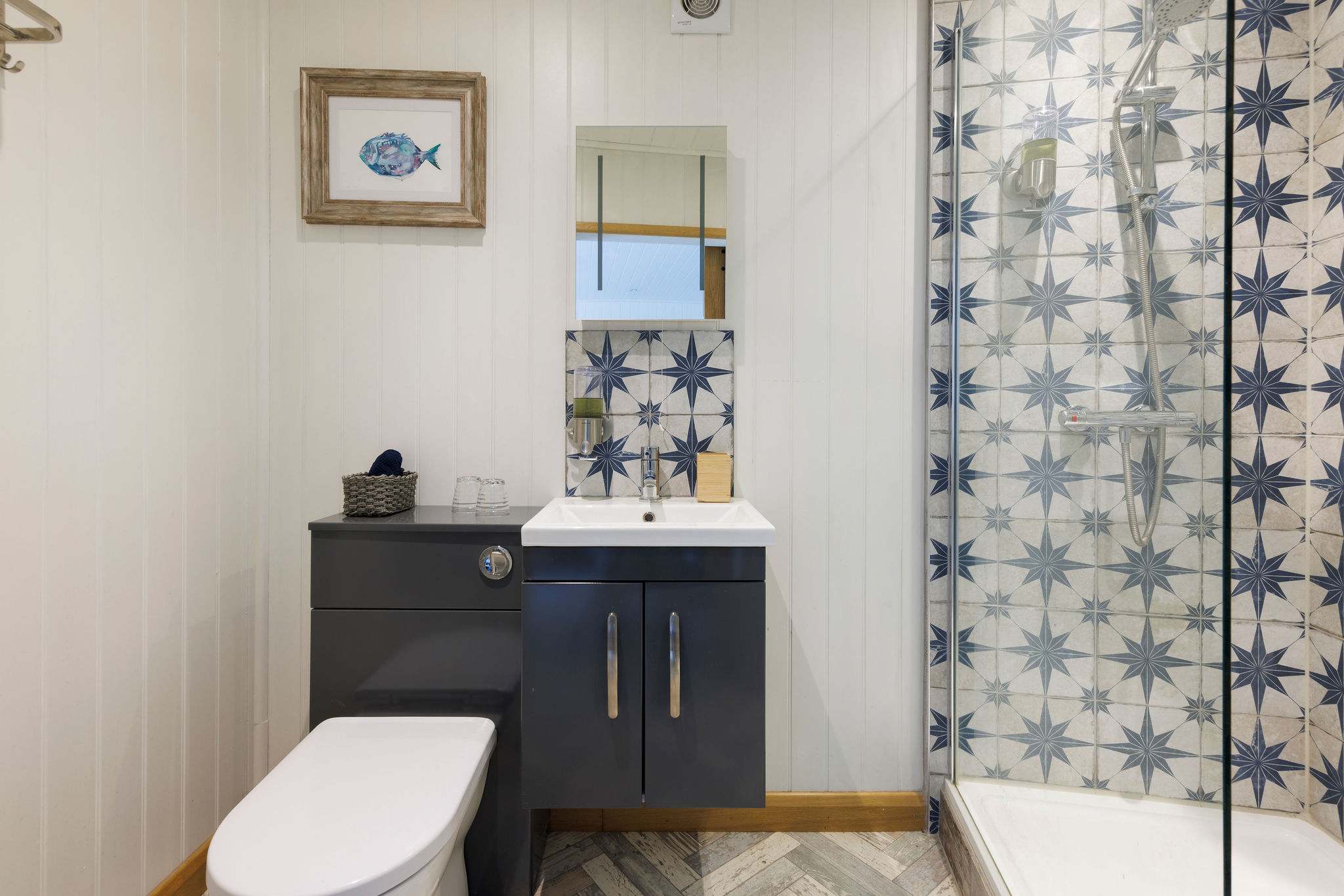 The surprisingly spacious ensuite bathroom features a huge walk-in shower, large mirror, WC and sink.