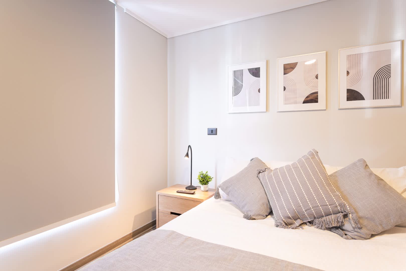 Relax in this stylish and serene bedroom, complete with modern decor and a cozy ambiance, perfect for a restful stay.