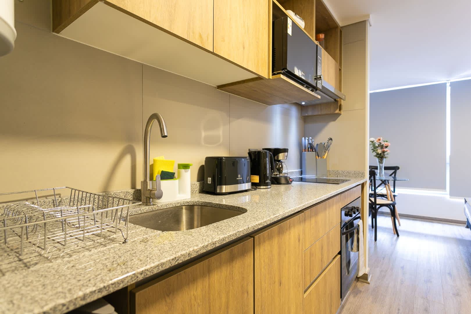 Experience culinary delight in this sleek kitchen, equipped with modern appliances and a cozy dining area.