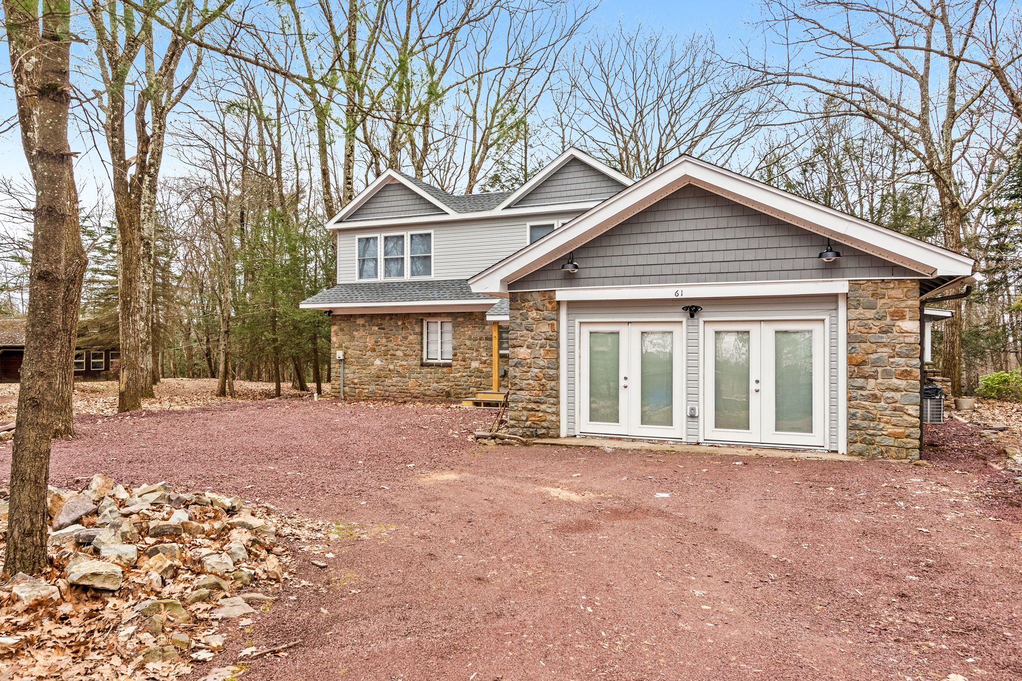 Spacious Outdoor Setting
A wide-open driveway and surrounding wooded landscape make this home feel like a private retreat, perfect for guests looking for tranquility and space to explore.