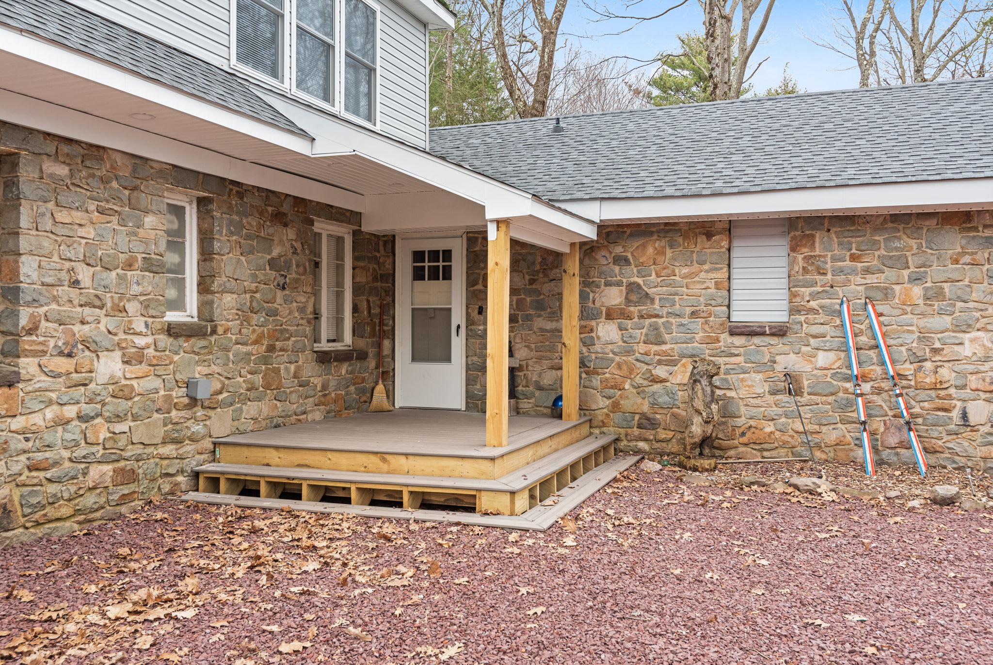 Welcoming Side Entrance
A charming covered entryway with a rustic stone wall and wooden details provides a warm welcome every time you return from a day of adventure.
