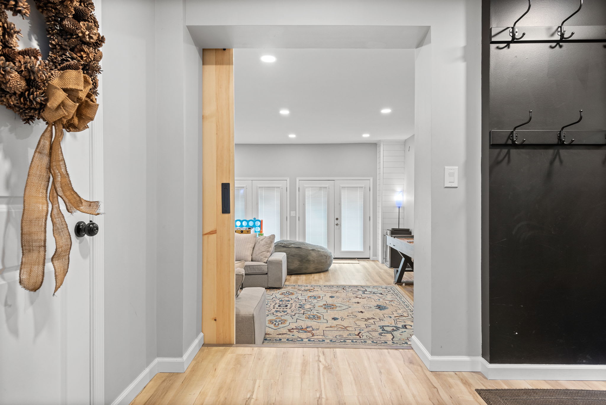 Rustic Barn Door Elegance
A stylish barn door leads to a peaceful hideaway, adding a touch of character while maintaining an open and airy feel throughout the home.