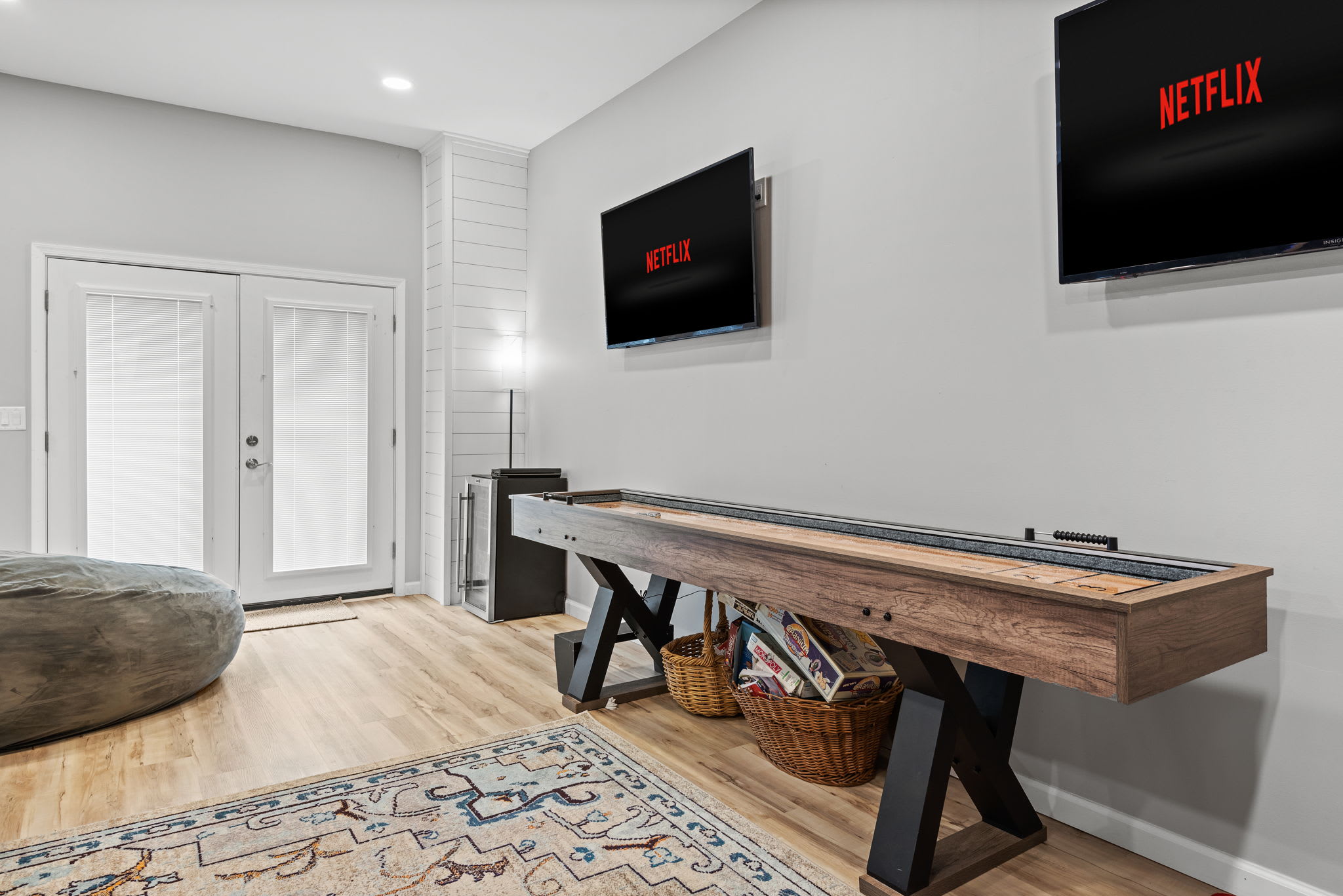 Spacious Game Room with a Social Vibe
This inviting space is designed for entertainment, with a shuffleboard table, comfortable seating, and a sleek TV setup, perfect for unwinding after a day of adventure.