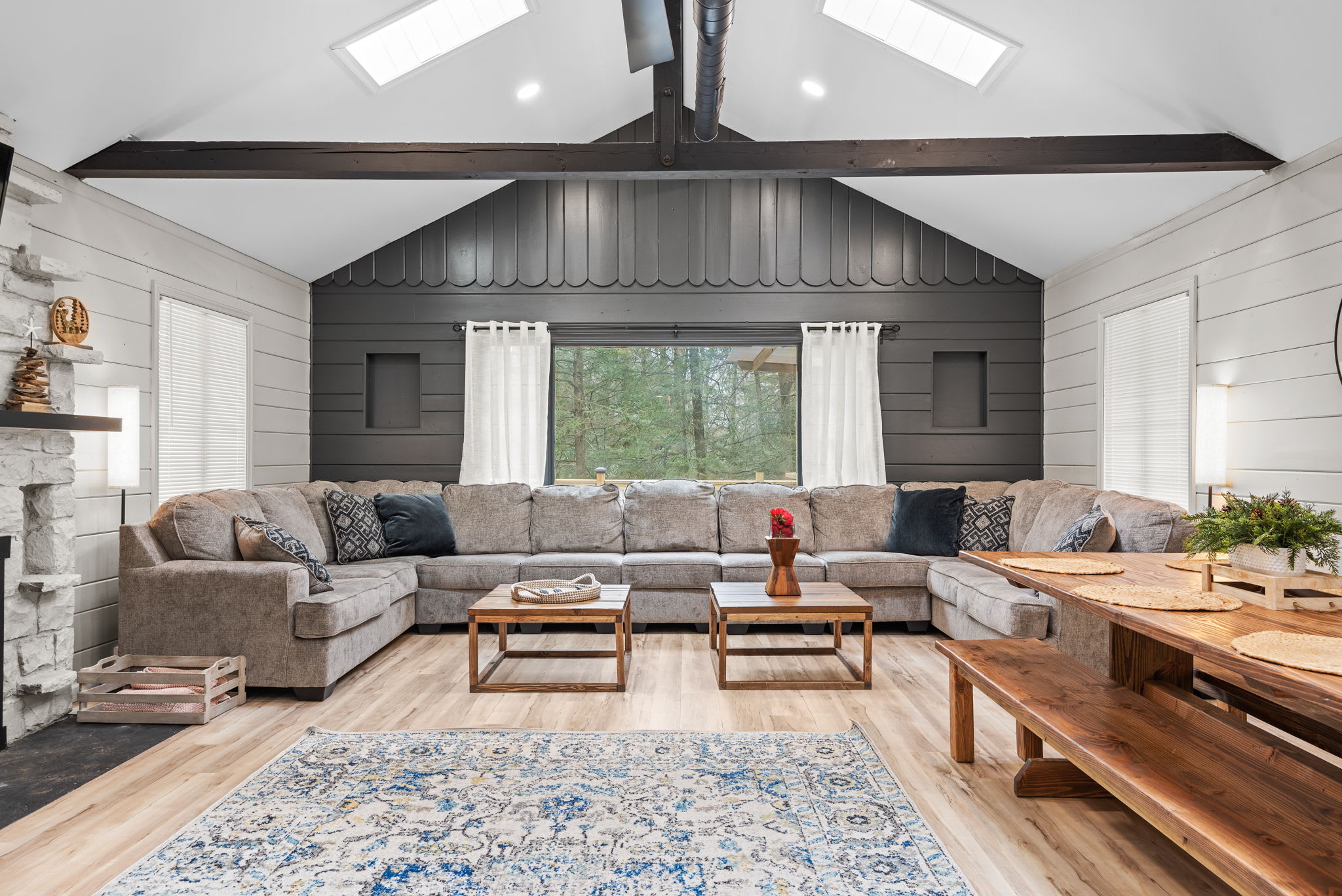 Cozy & Inviting Living Space
A harmonious mix of modern and rustic charm, this living area features a grand sectional, warm wood accents, and an open layout perfect for socializing.