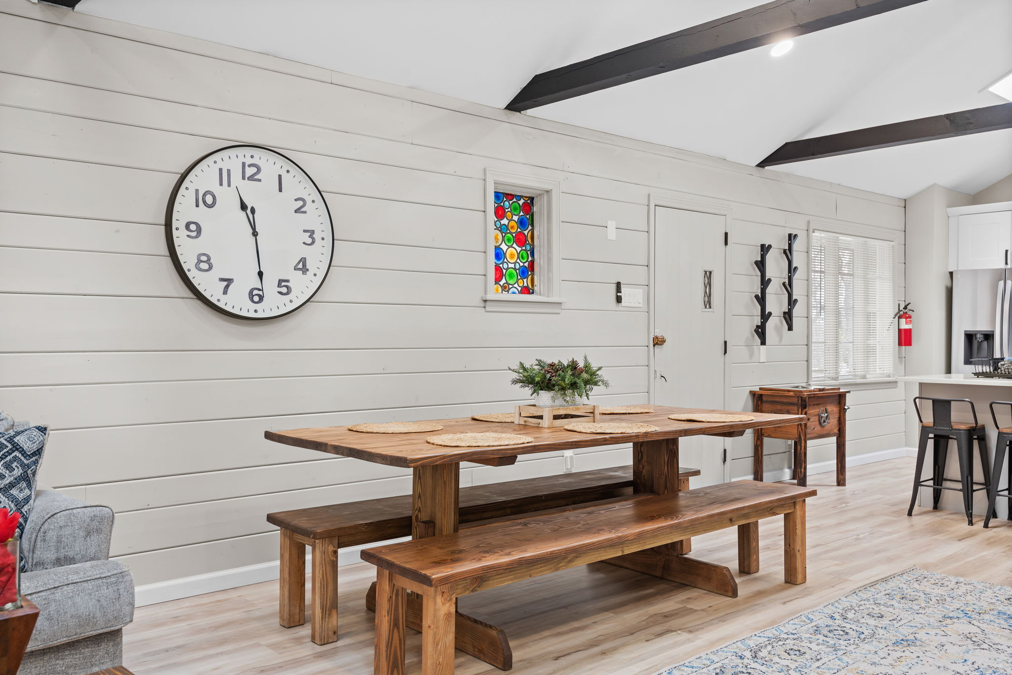 Rustic Dining with a Modern Touch
This spacious dining area features a beautiful wooden farmhouse table, high vaulted ceilings, and cozy shiplap walls perfect for enjoying meals together in style.