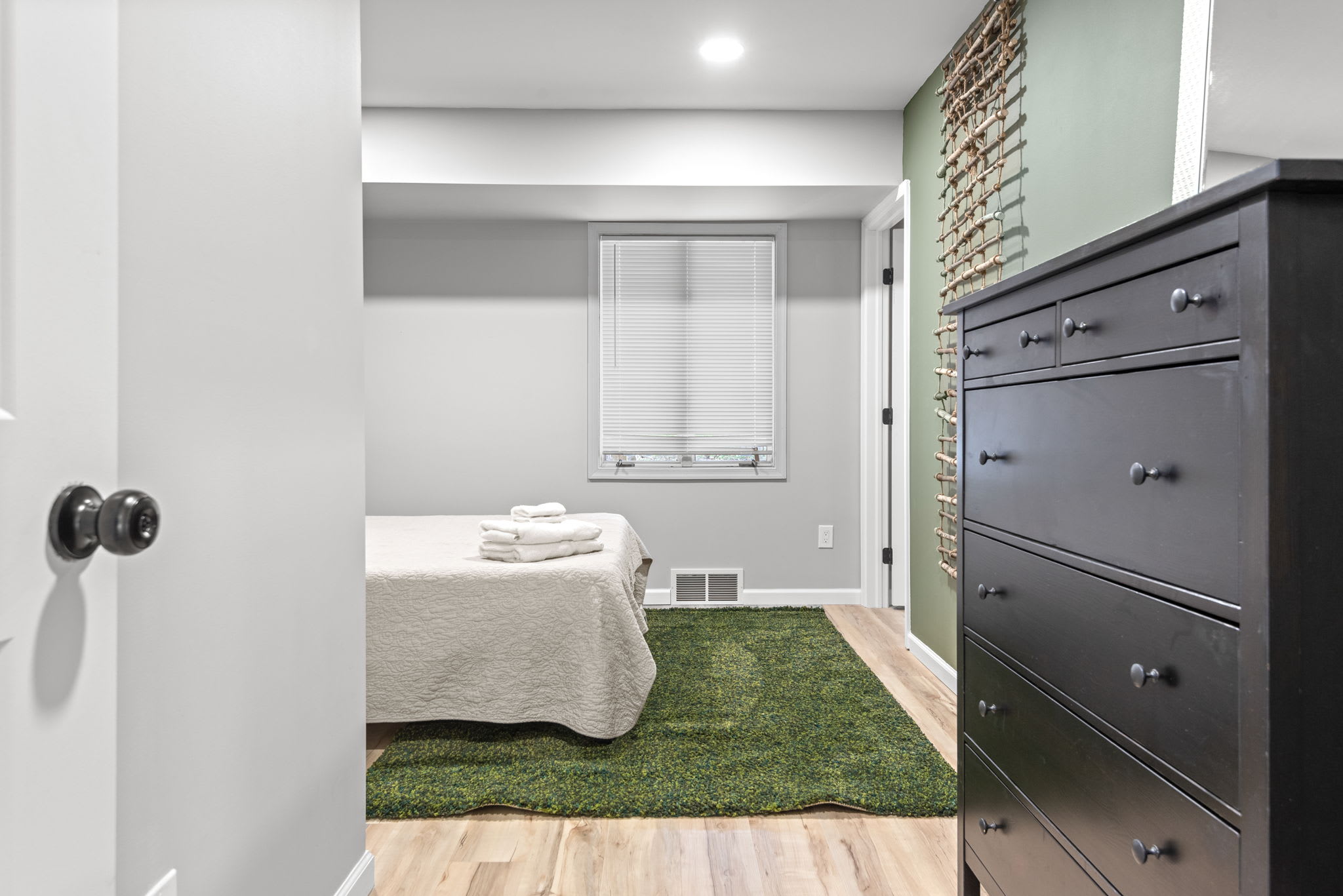 A Cozy & Serene Retreat
Step into this calming bedroom featuring soft green tones, warm wooden accents, and cozy lighting. A perfect place to rest after a day of adventure.