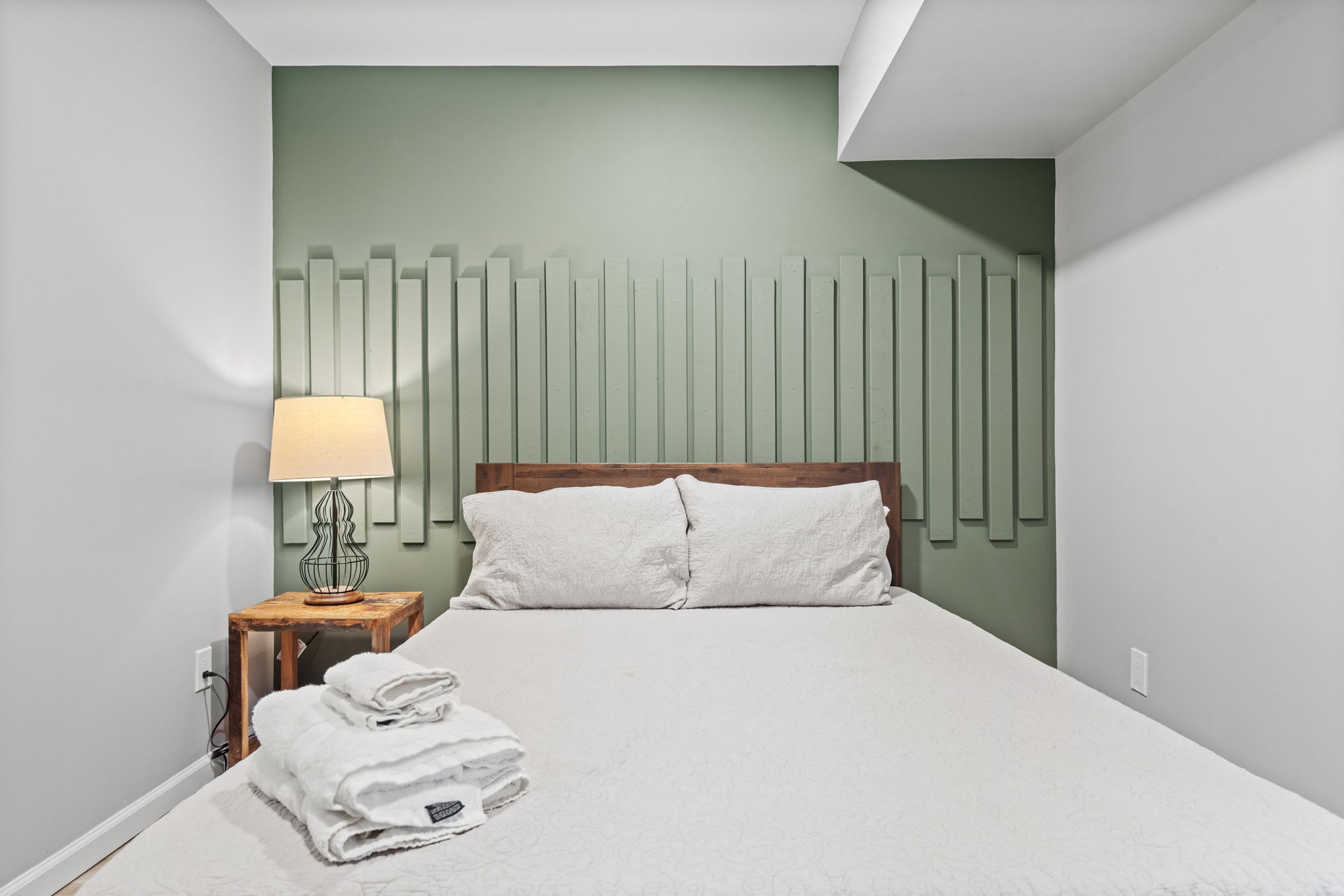 Featuring a plush bed, warm lighting, and a touch of rustic charm, this room is designed to provide a peaceful and restful stay.