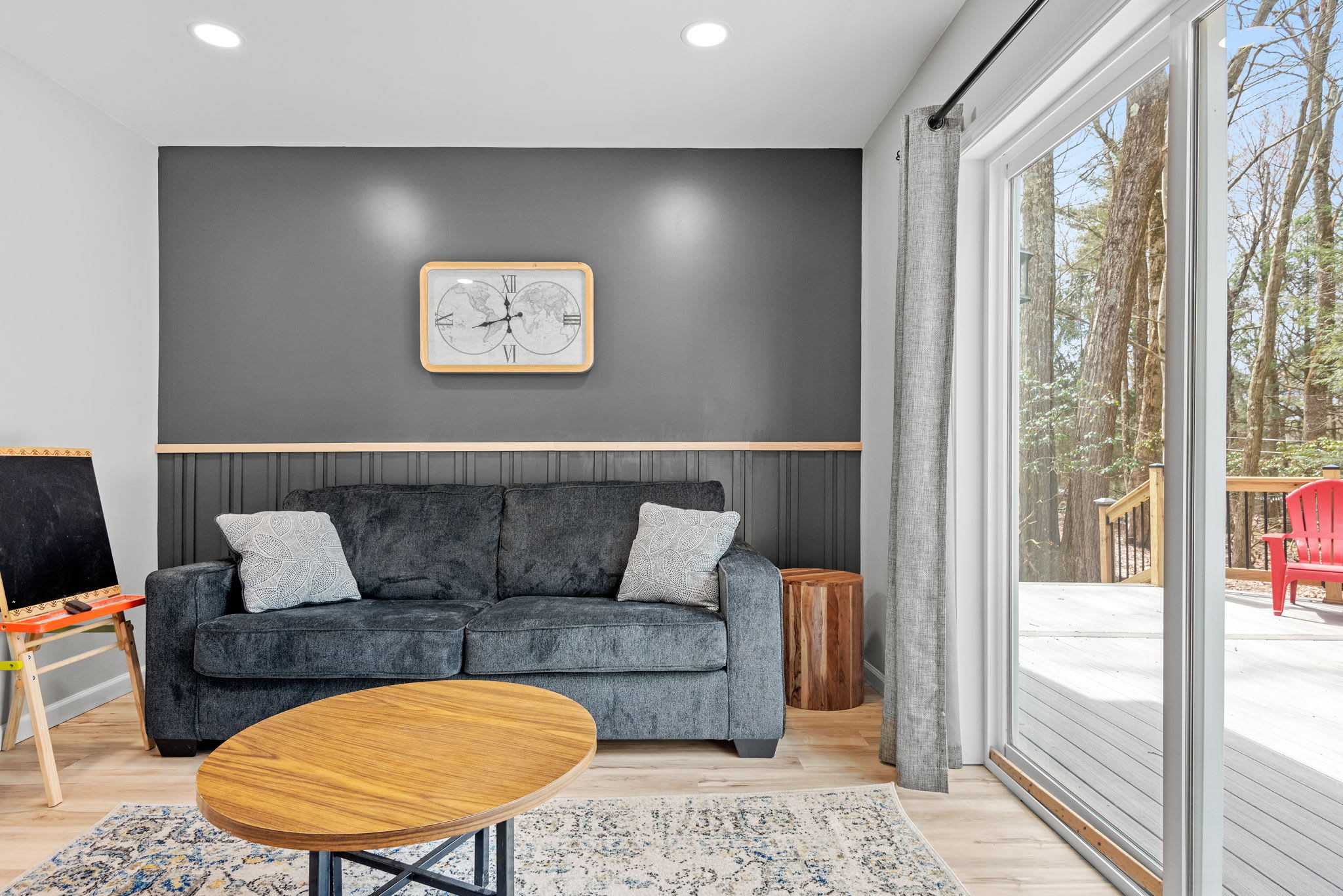 Whether used as a bedroom or a relaxing lounge, this space offers a plush sofa bed, cozy ambiance, and direct outdoor access for the perfect mix of comfort and convenience.
