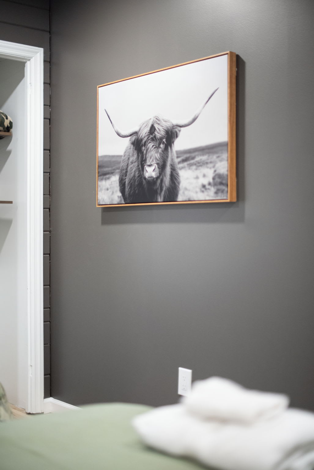 Dark accent walls and natural wood elements give this room a cozy, yet sophisticated feel, making it an ideal spot to unwind after a long day.
