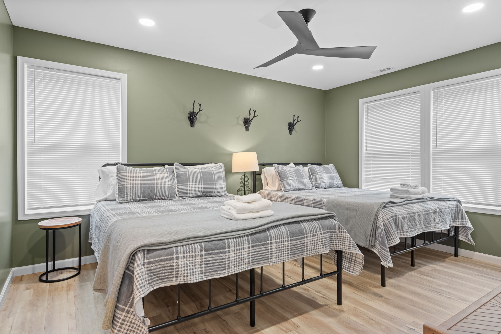A Tranquil & Cozy Escape
Featuring two plush beds, soft green walls, and warm lighting, this room is the perfect retreat for families or friends looking to relax in comfort.