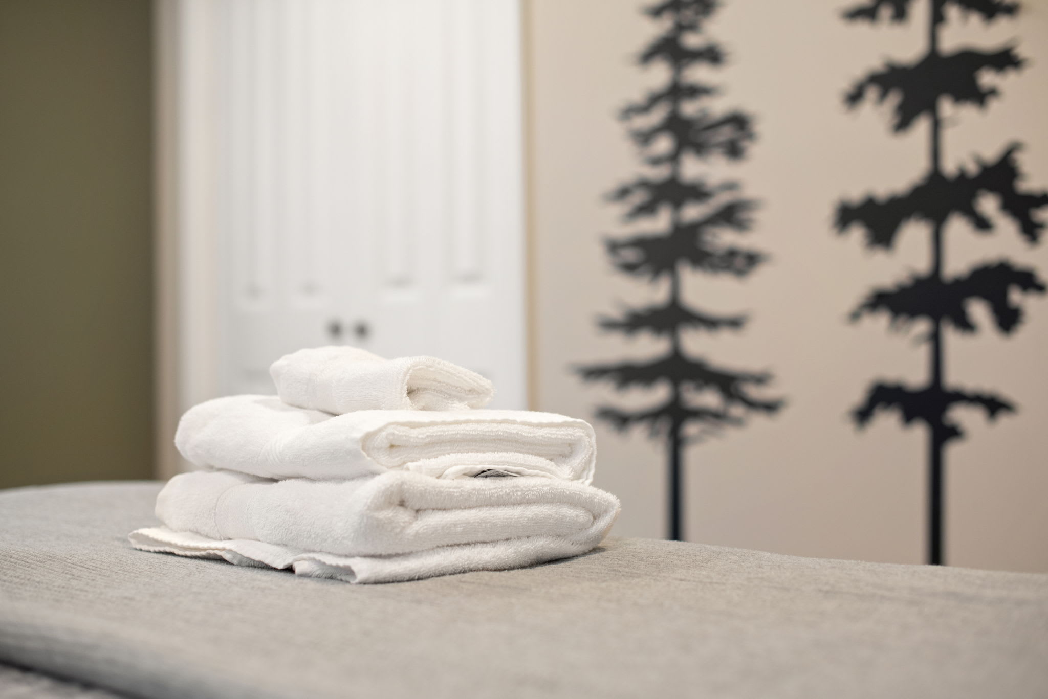 A beautifully designed space with forest wall art and soft lighting, making it a perfect blend of relaxation and style.