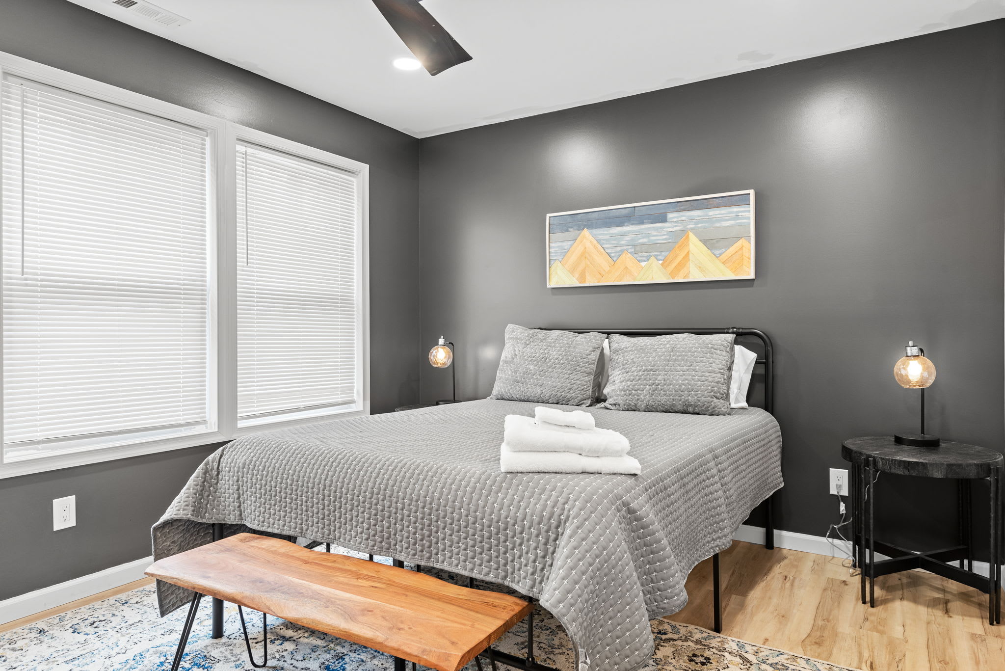 Modern Elegance Meets Comfort
A cozy yet refined bedroom with a stylish bench, geometric artwork, and soft lighting, making it an inviting space to relax and recharge.
