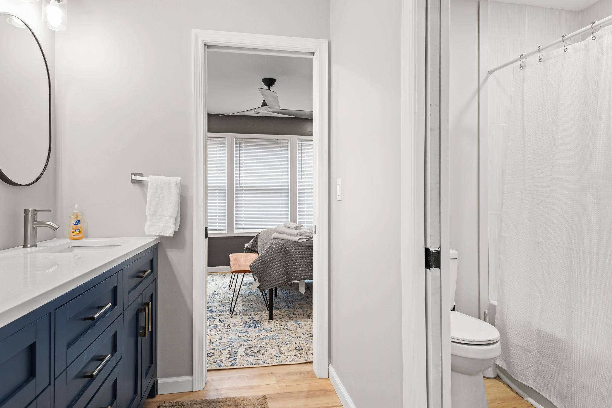 A bright and airy bathroom with a clean white shower curtain, sleek fixtures, and a calming color palette for a refreshing experience.
