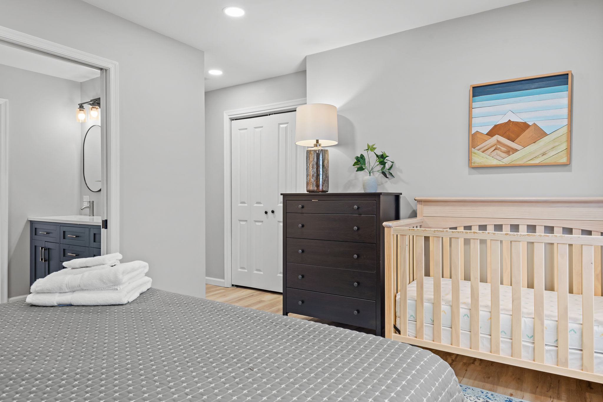 This well-designed bedroom seamlessly blends style and function, offering ample space for both relaxation and convenience, complete with soft lighting and tasteful décor.