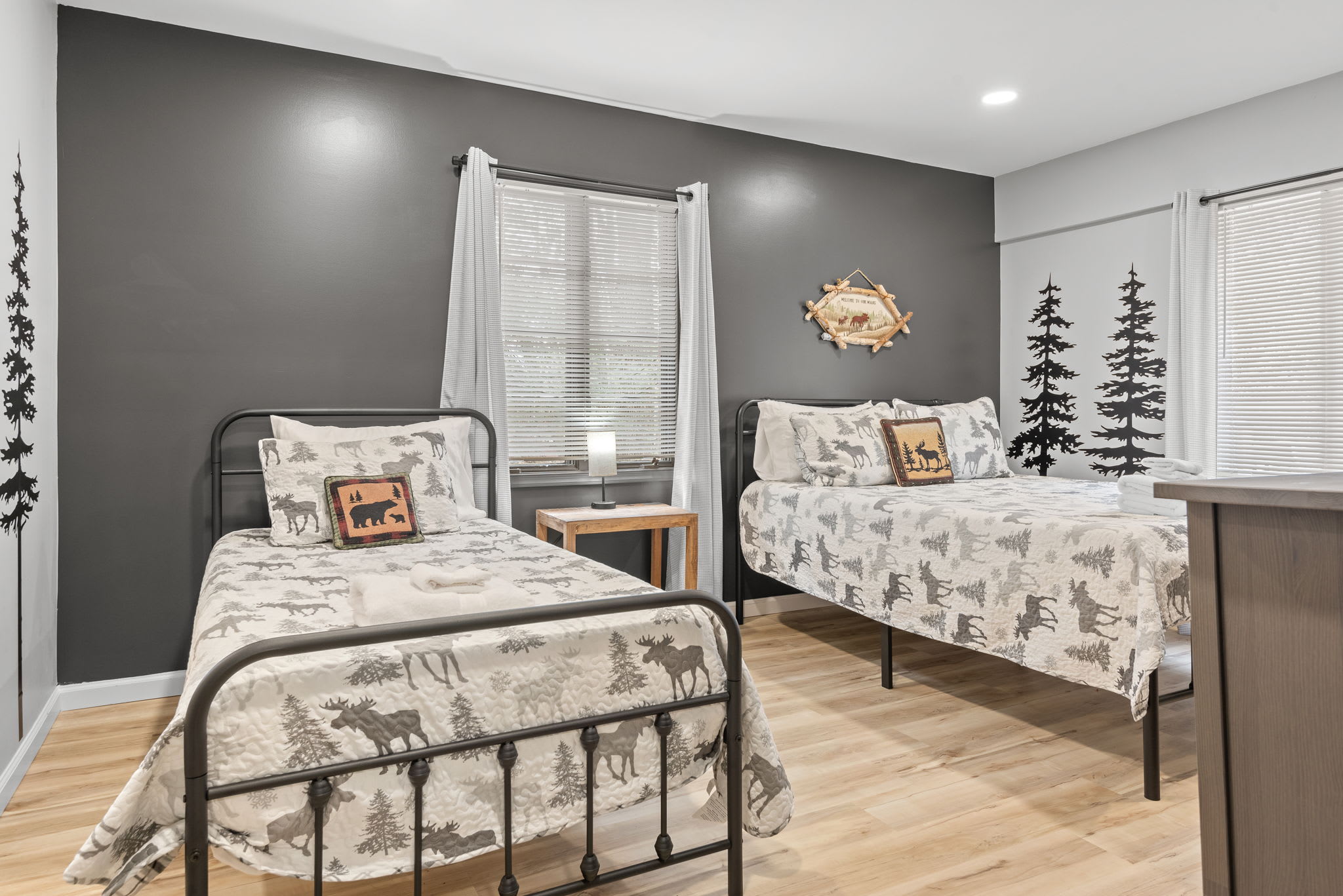 Perfect for Families & Friends
With beds, stylish rustic decor, and woodland wall accents, this room is designed for both comfort and character ideal for those seeking a cozy mountain getaway.