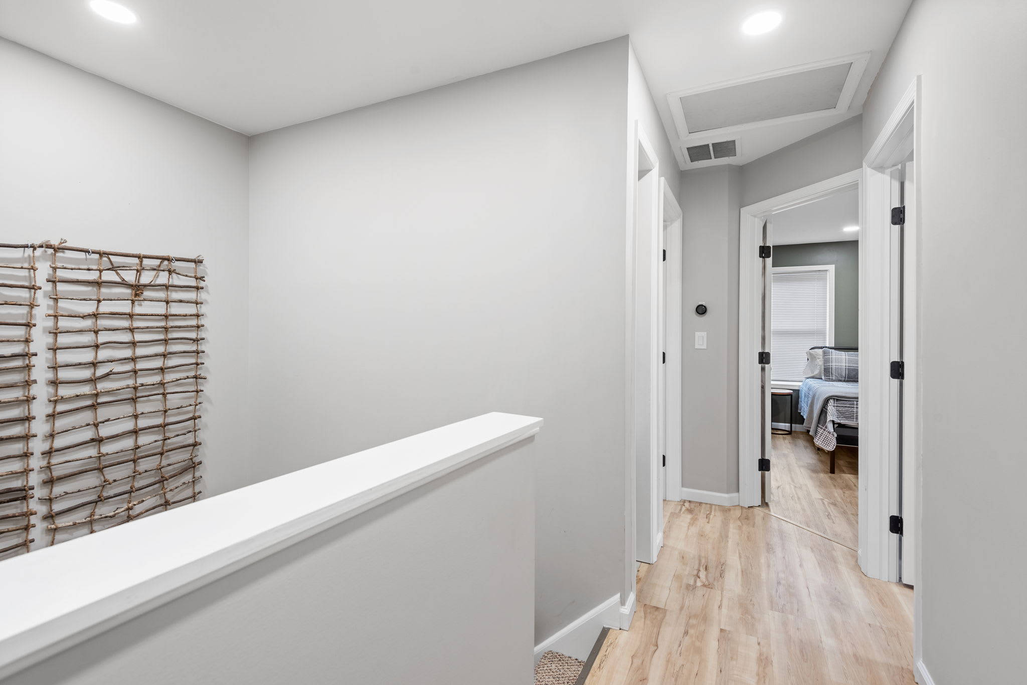 Bright & Airy Hallway
A modern and open hallway with warm wood flooring and soft lighting, leading to the home’s inviting bedrooms and living spaces.