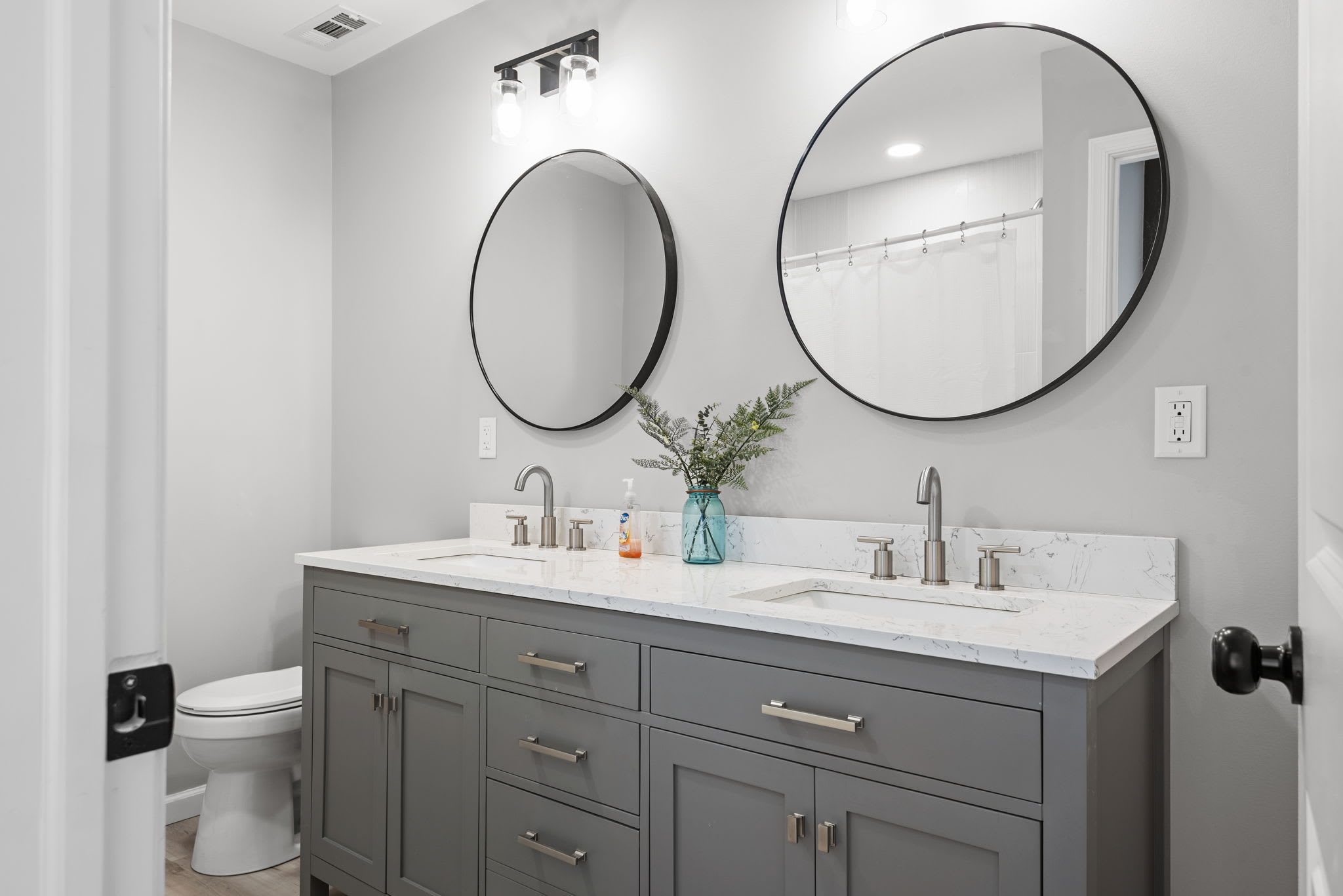 Sleek & Stylish Double Vanity Bathroom
A beautifully designed bathroom featuring a spacious double vanity, elegant round mirrors, and modern fixtures offering both function and style for a refreshing experience.