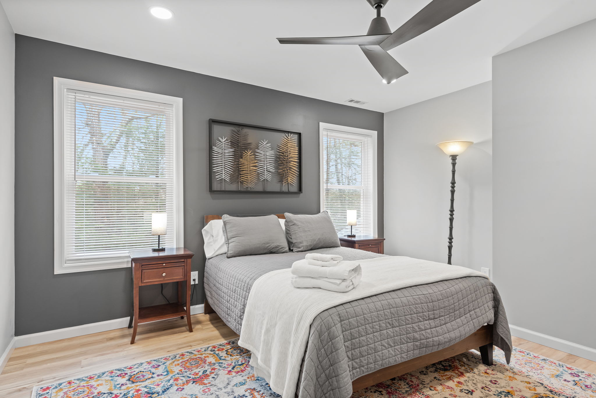 A Serene & Modern Getaway
This stylish bedroom features a sleek gray accent wall, soft neutral bedding, and beautiful natural light, making it a cozy and refreshing retreat.