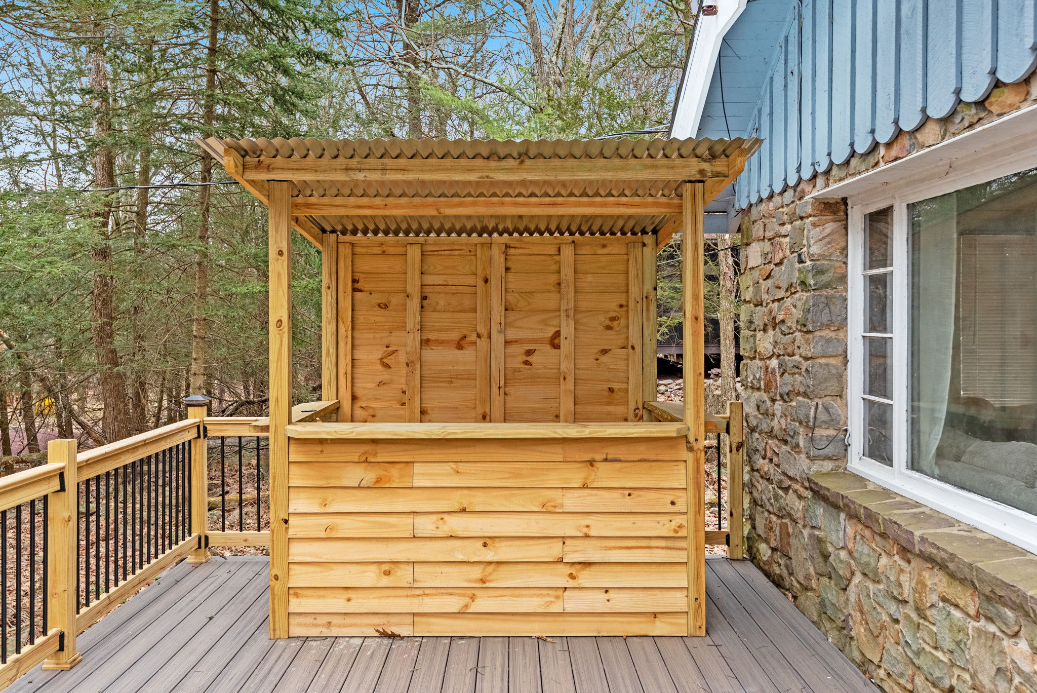 Charming Outdoor Bar on the Deck
A unique wooden bar area adds a fun and rustic touch to the outdoor deck, perfect for enjoying drinks and conversations in the fresh mountain air.